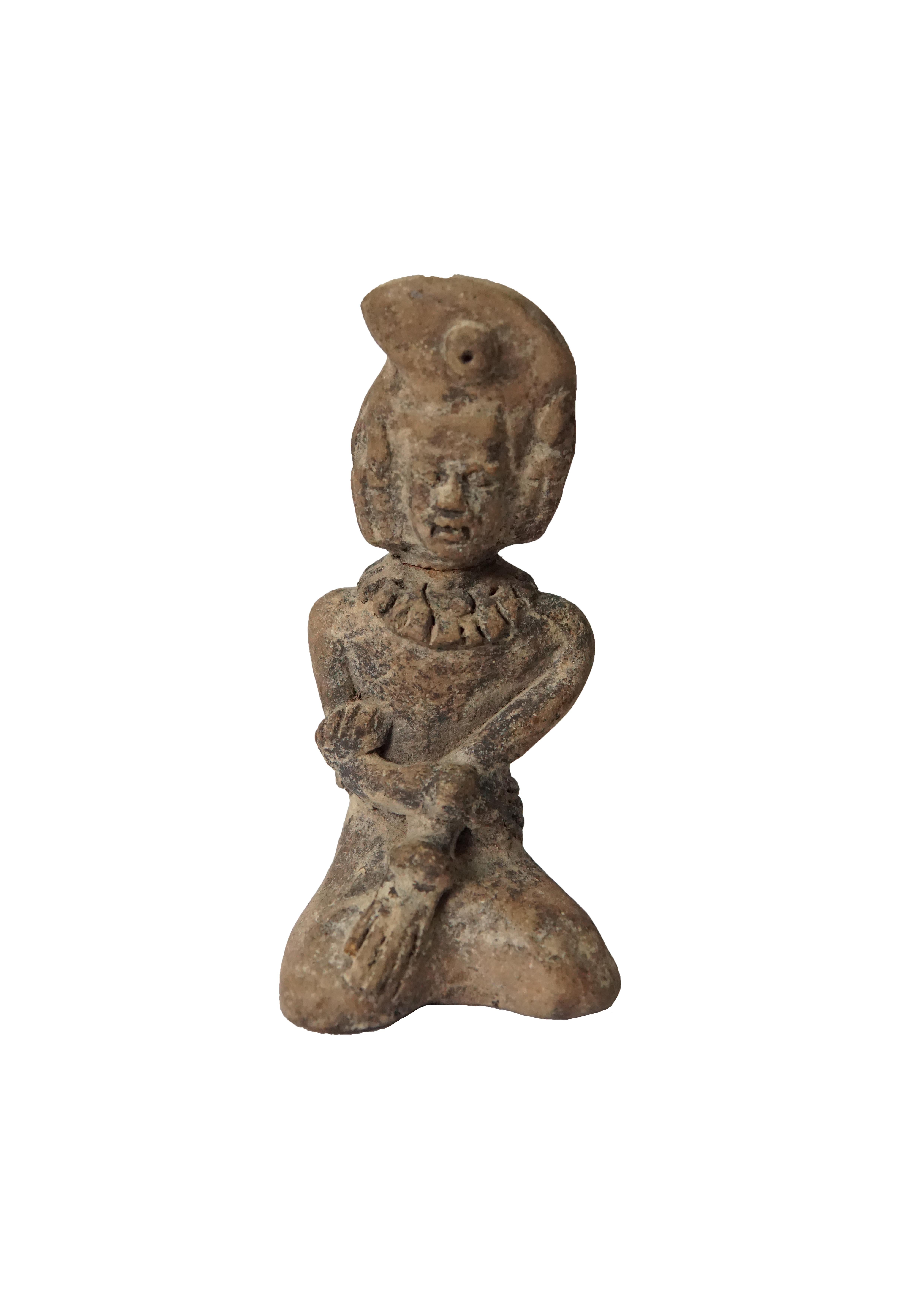 A visibly old pair of mold-formed terracota women kneeling, dating to the Majapahit Empire circa the 15th century. These were excavated amongst the shrines of Mount Penganggungan, East Java, Indonesia. Terracotta pottery was an important craft