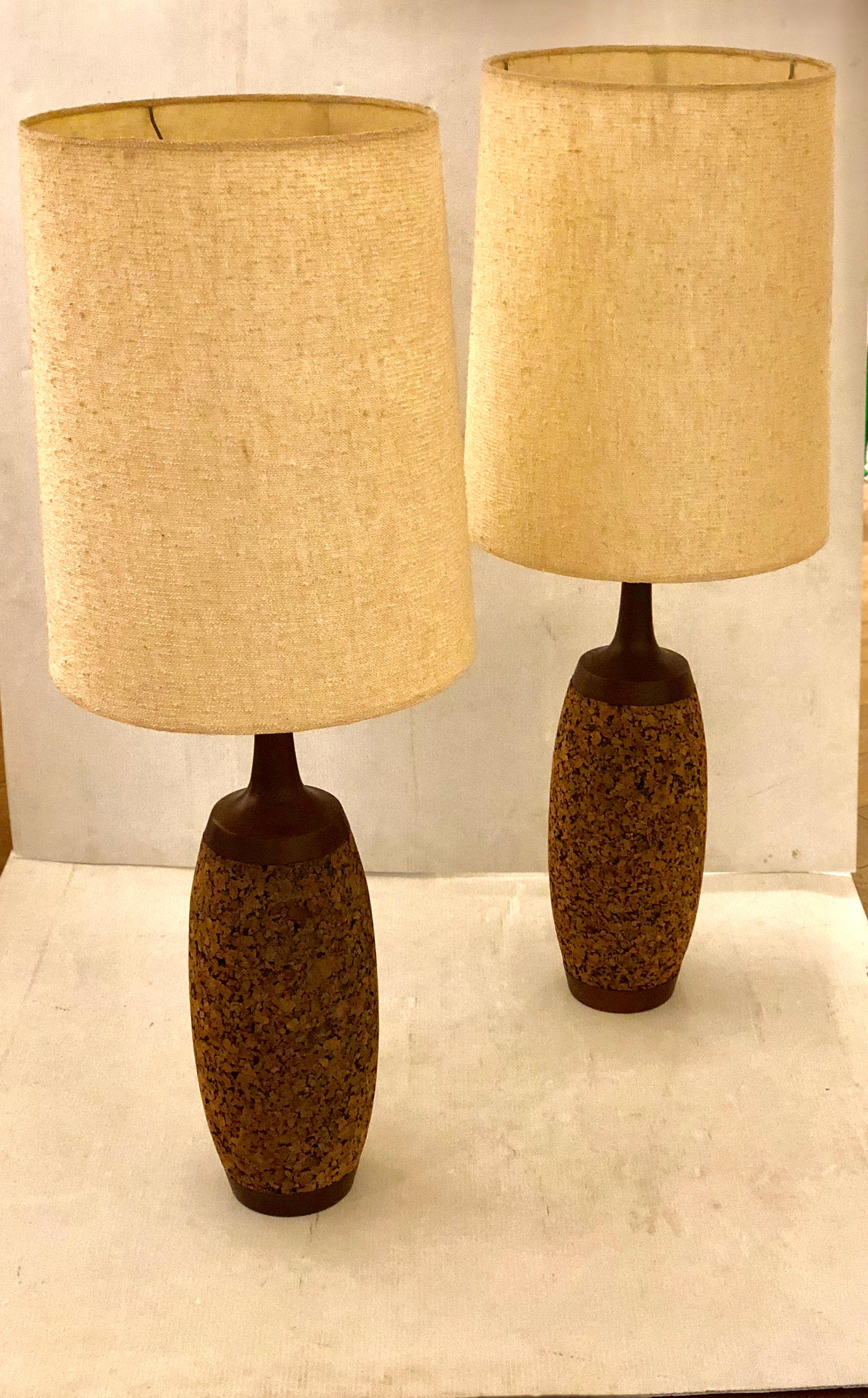 Great pair of tall table lamps in cork with walnut and brass fittings and original lampshades , very clean and nice condition. The lampshade alone its 21