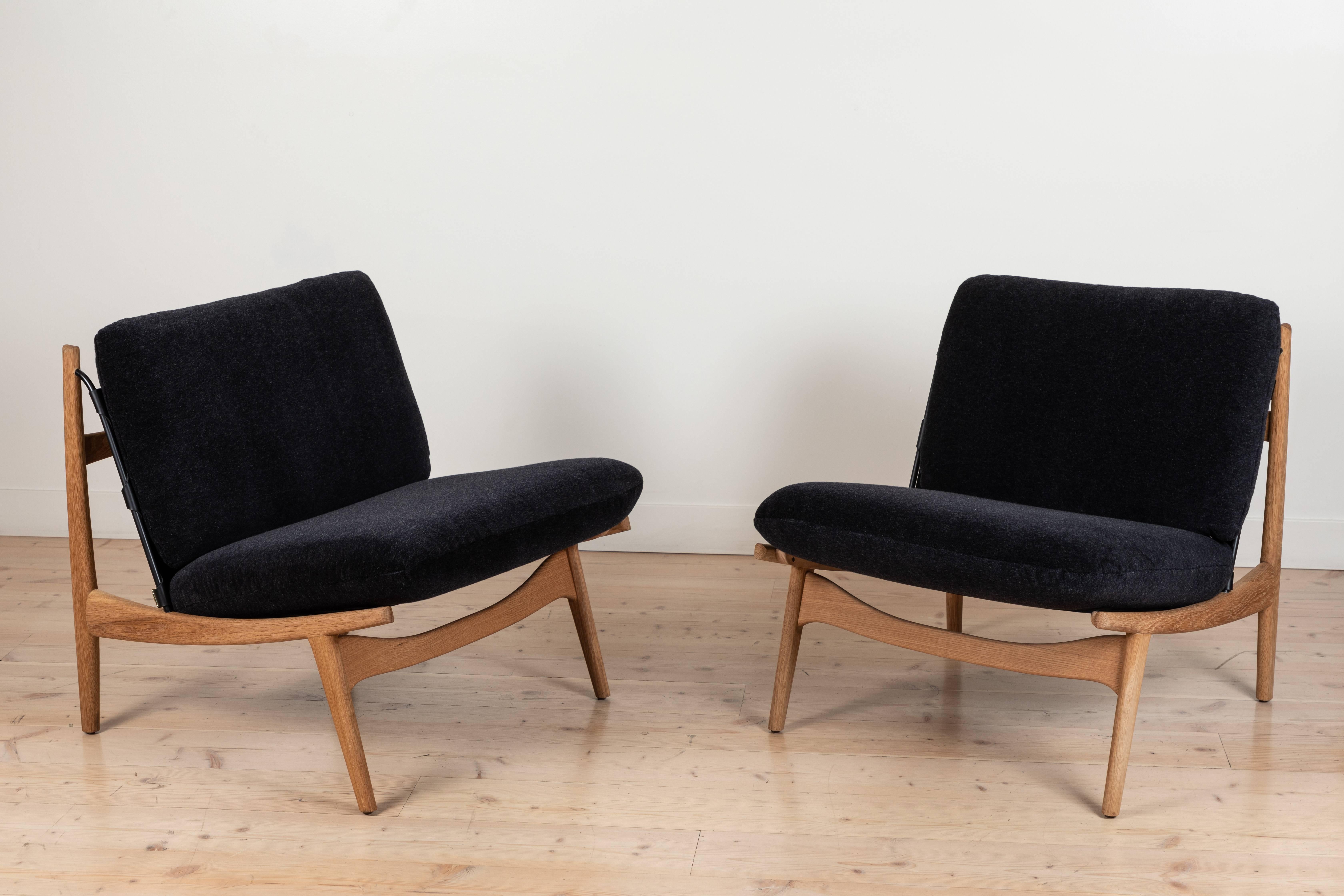 The Maker’s Lounge Chair is a solid walnut or oak frame chair with a leather sling that features brass details on the seat and back. Loose seat and back cushions are included. Shown here in Oiled Oak and Alpaca Mohair.

Available to order in
