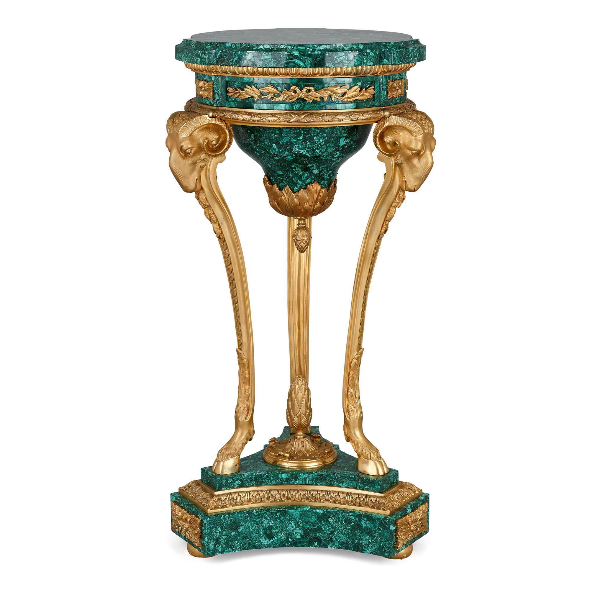 Pair of malachite and gilt bronze stands in the Neoclassical style
French, 20th century
Measures: Height 88cm, width 47cm, depth 39cm

Each pedestal in this pair, wrought from gilt bronze and malachite, is based on the shape of a Classical Greek