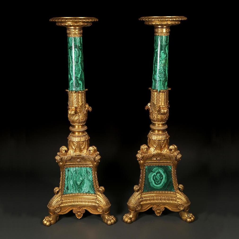 Highly Important Pair of Malachite and Ormolu Torchere by Thomire.
With round black marble on top with egg-and-dart moulding; acanthus-sheathed columnar upright, on an incurved tripartite base, the angles cast with cherubs trailing bellflowers to