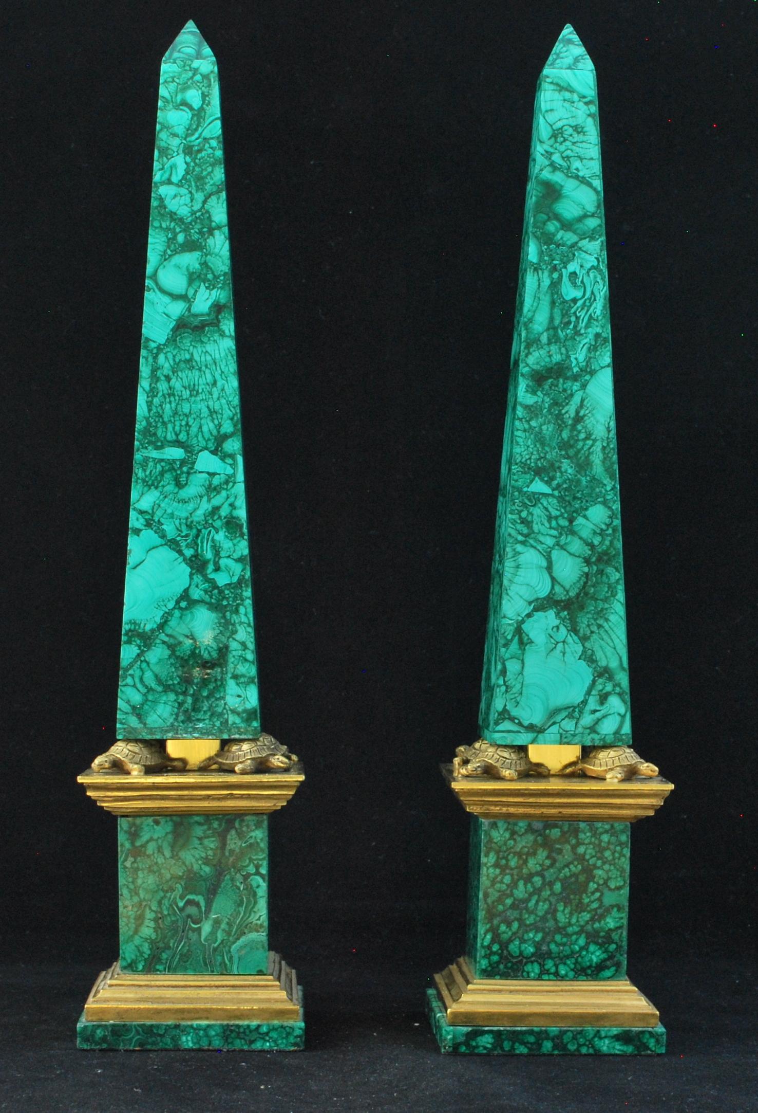 A striking pair of obelisks, in ormolu with malachite facings. The obelisks are supported on the backs of ormolu turtles, adding charm and interest.