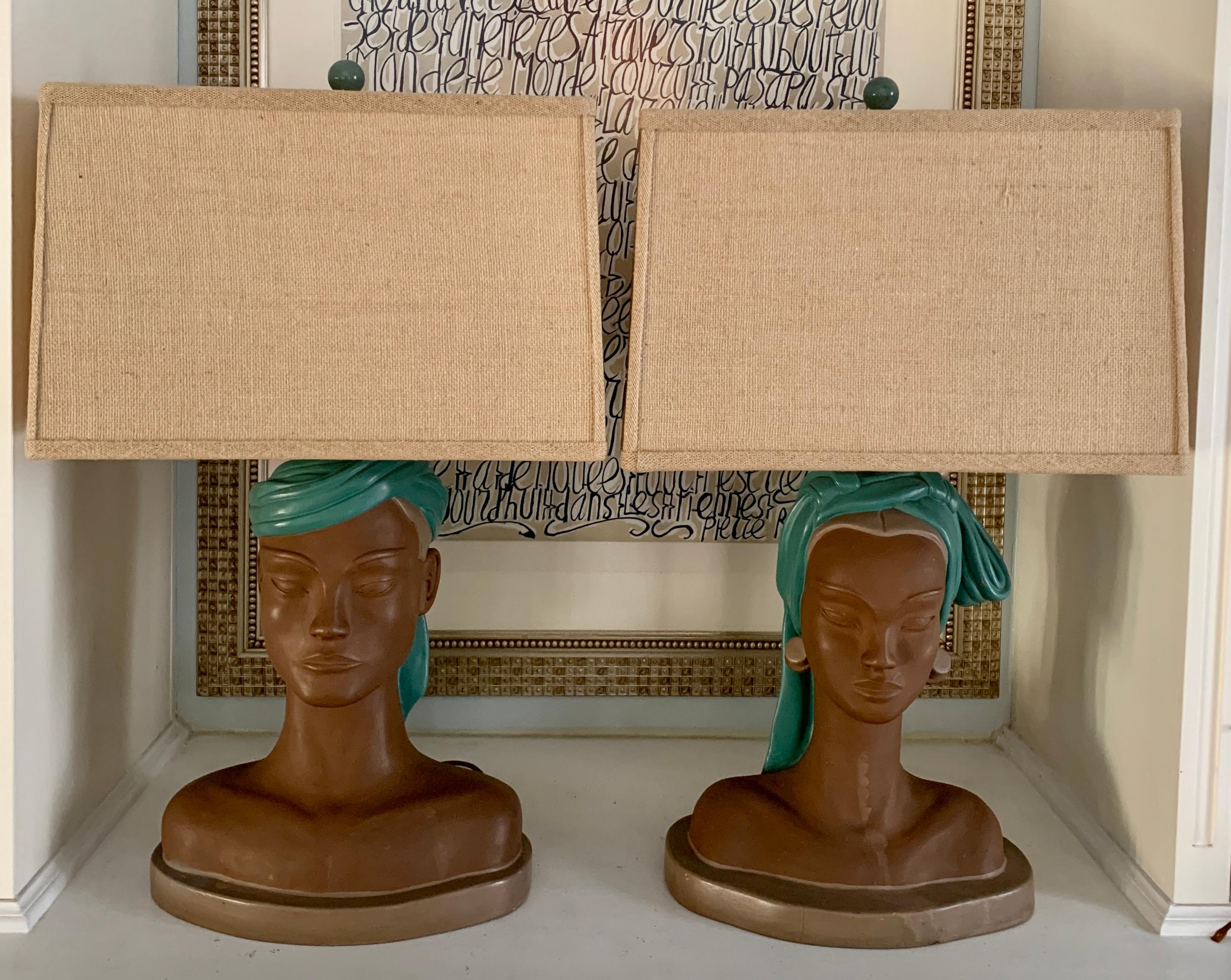 A pair of male and female ethnic figural bust lamps. 

While these resemble Hawaiian in style, they would work well in many corresponding environments. The lamps are plaster and in good condition overall. The custom woven shades are included with