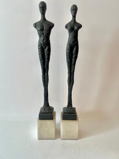 Pair of Male and Female Sculptures on Marble Stands in the Style of Giacometti