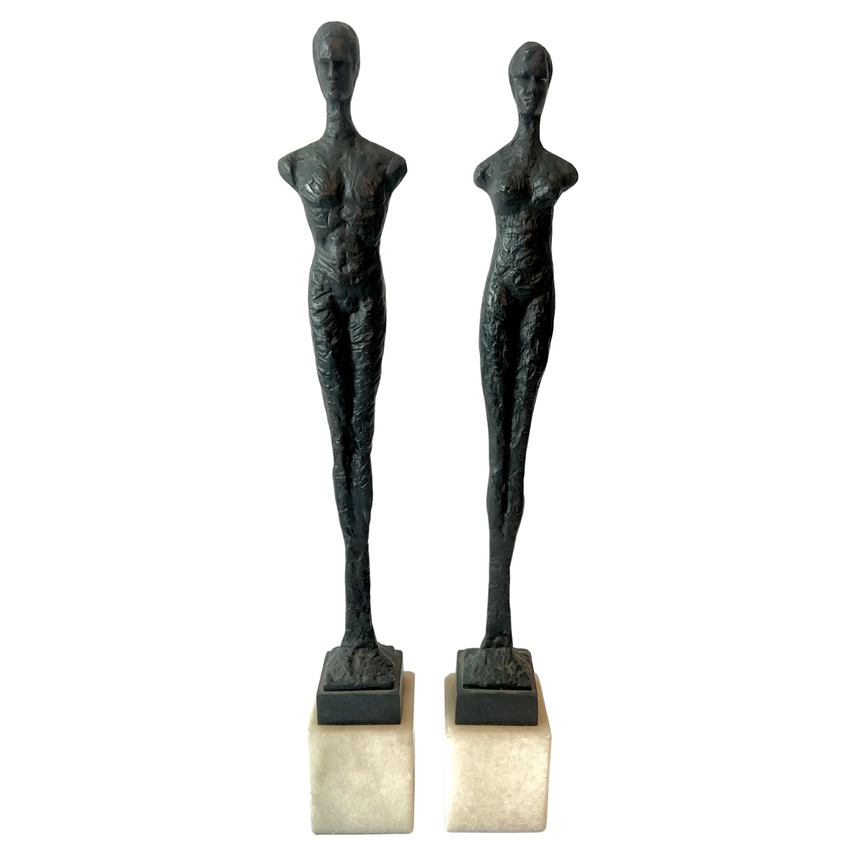 Pair of Male and Female Sculptures on Marble Stands in the Style of Giacometti
