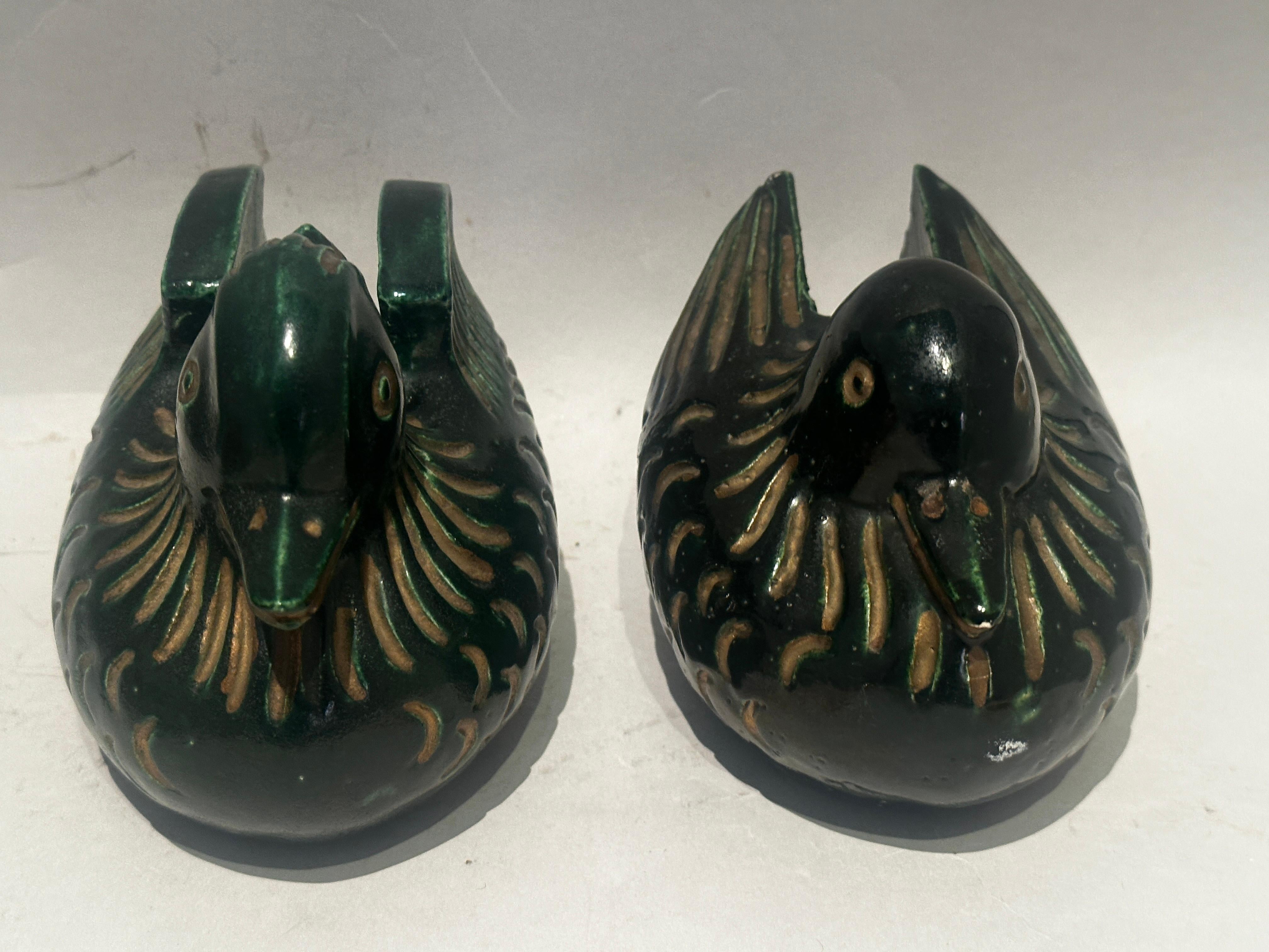 Pair of Japanese hand cast Mandarin duck screen holders. Glazed ceramic with cutouts to allow ends of standing screens to securely rest inside them. Called bayou-hasami or bayou-osae these holders were important in the summer when screens were used