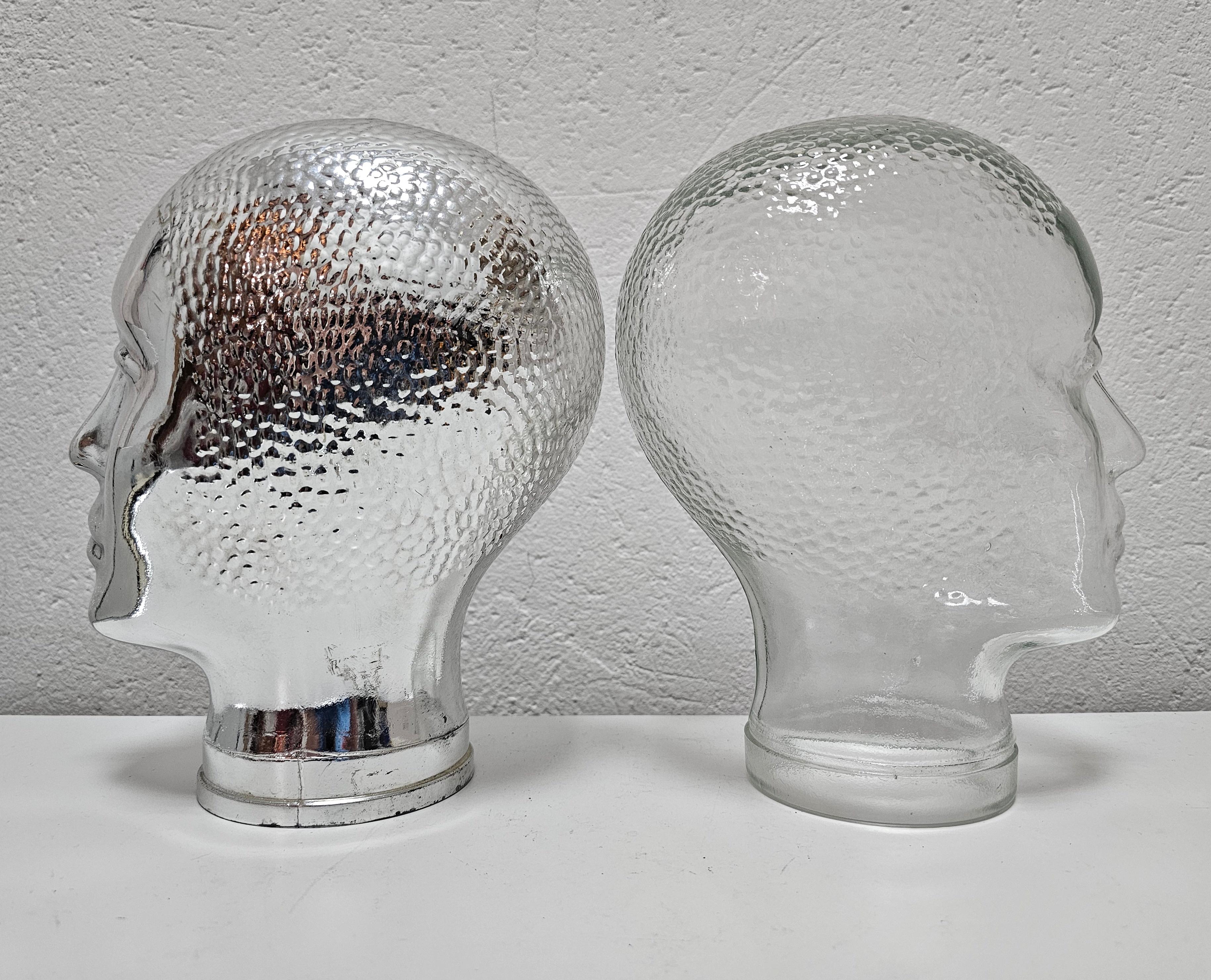 In this listing you will find a pair of Mid Century Modern mannequin glass heads, renowned Italian designer. One head is done in clear and the other in silver glass. Made in Italy in 1960s.

Very good vintage condition. There are no dents on the