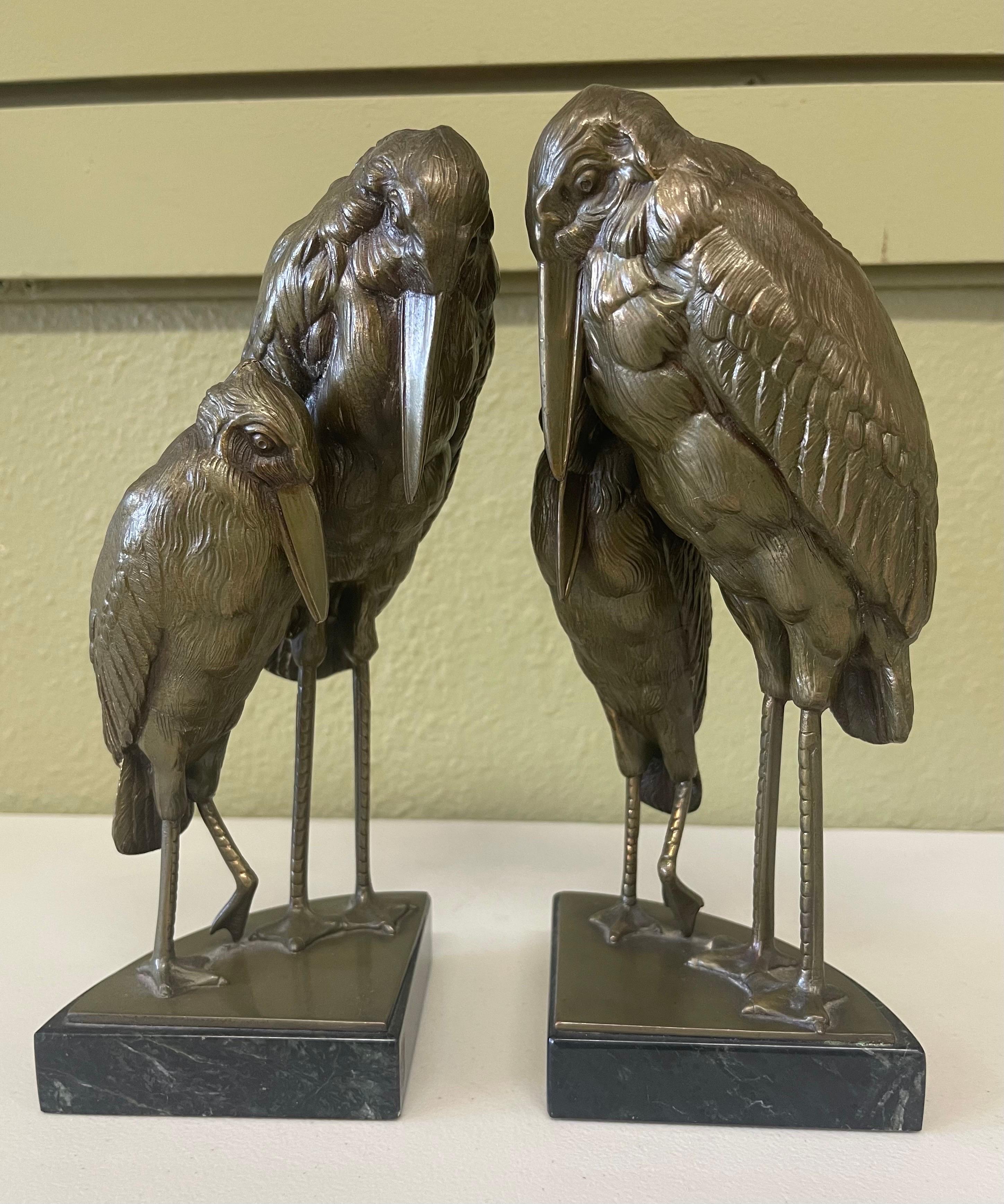 Gorgeous pair of marabou stork Art Deco bookends in the style of Marcel-Andre’ Bouraine, circa 1930s. The bookends are made of bronze on black marble bases with two cast bronze stork figures in the “Vienna Bronze” style. The large birds measure 7.5