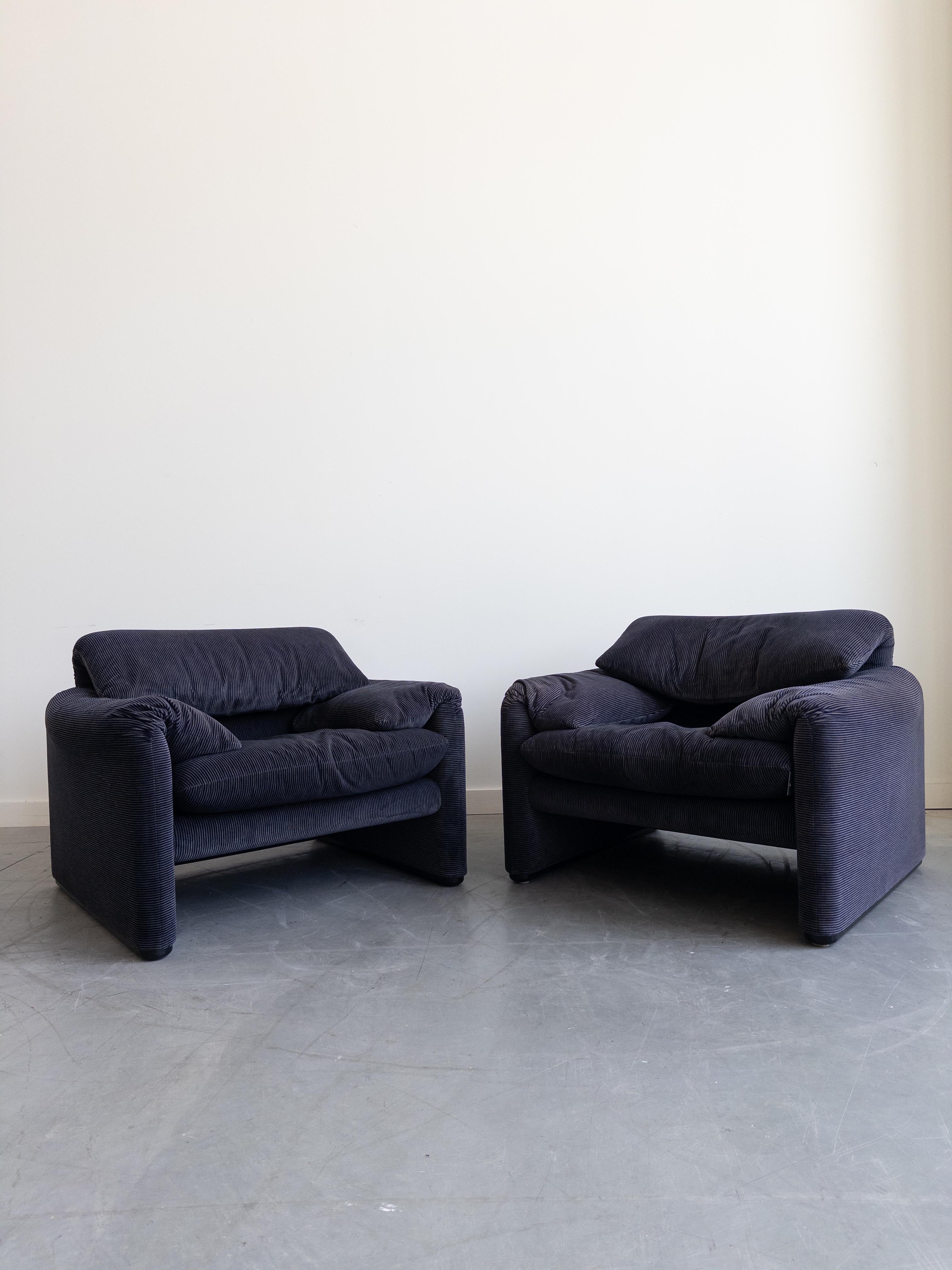 Vico Magistretti designed this lounge chair and ottoman for Cassina as part of his Maralunga Series in 1973. In 1979, the series won Italy's Compasso D'Oro award for Industrial Design. In its original striped dark blue upholstery, Tagged Cassina.
