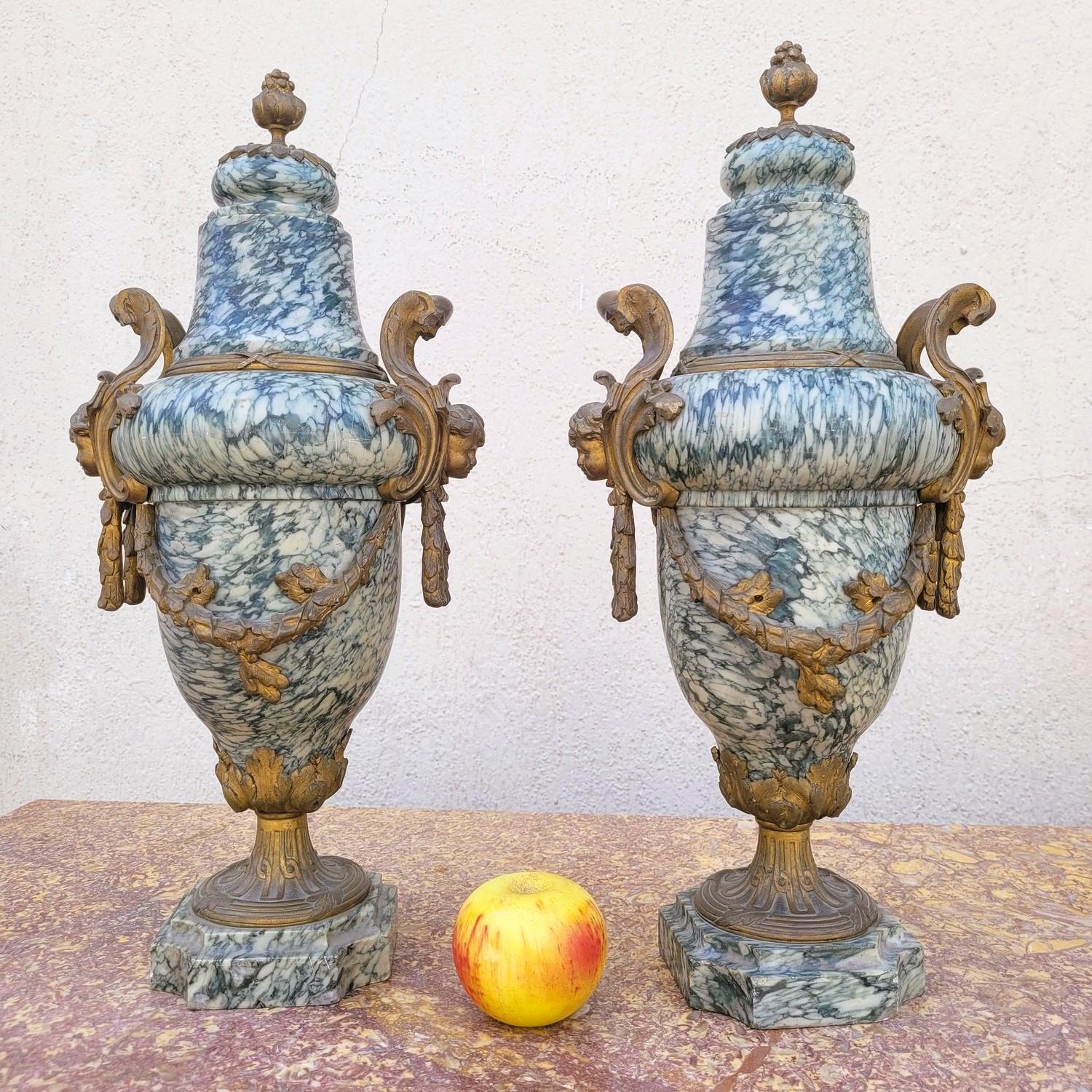 Coppia di cassette in marmo verde chiaro con ornamenti in bronzo dorato: ghirlande di fiori e foglie, teste di putti, coperchi di pigne

Alcuni segni di usura e graffi, vecchi restauri sul marmo

xIX secolo

Altezza 51 cm
23 x19 cm circa.