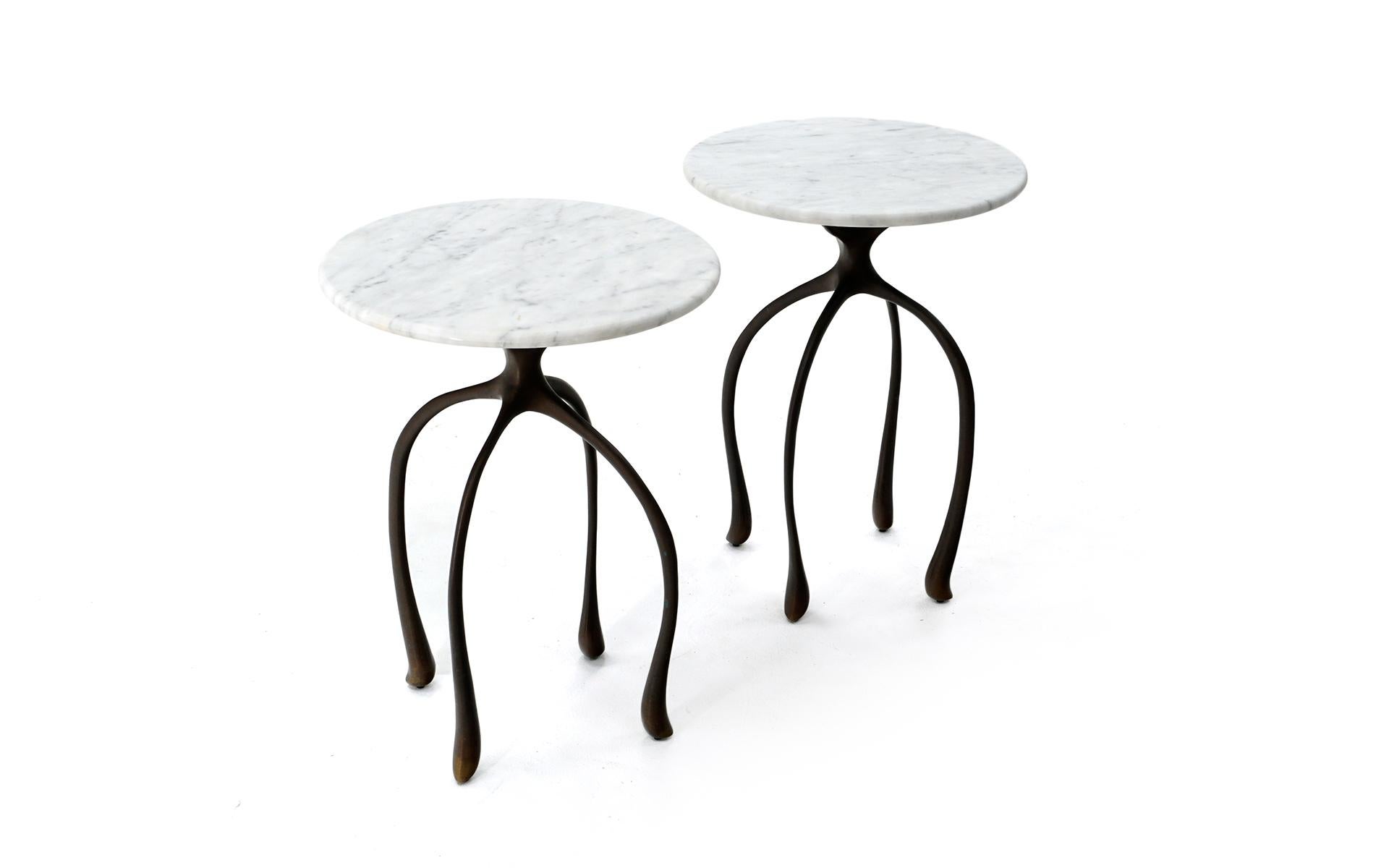 A pair of moonshine side / end tables designed and manufactured by Jordan Mozer, Chicago, IL. Round Carrara marble tops and sculptural cast solid bronze frames. Organic, unique forms. Heavy weight, outstanding construction. These are excellent and