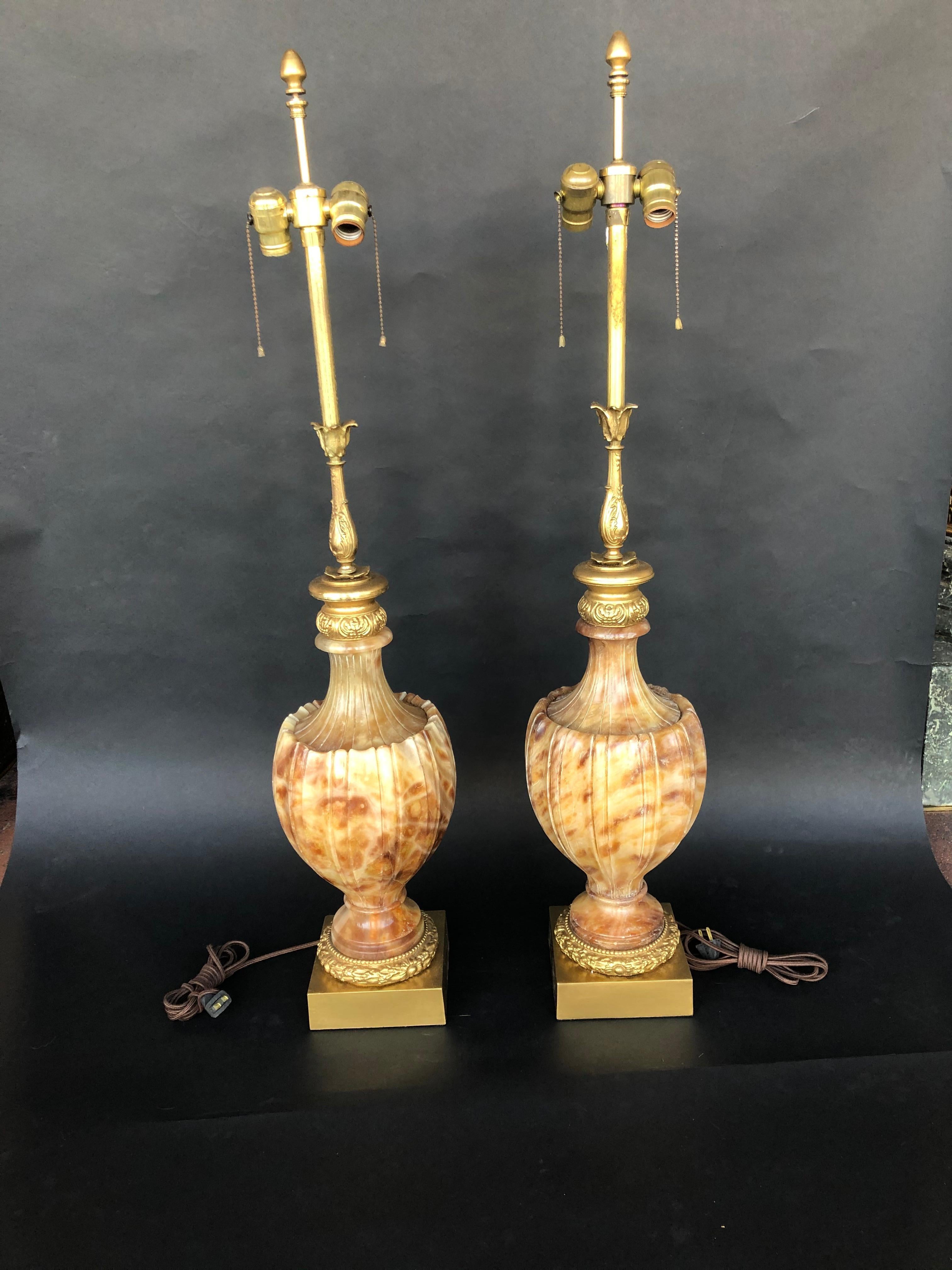 Two carved marble and onyx table lamps.