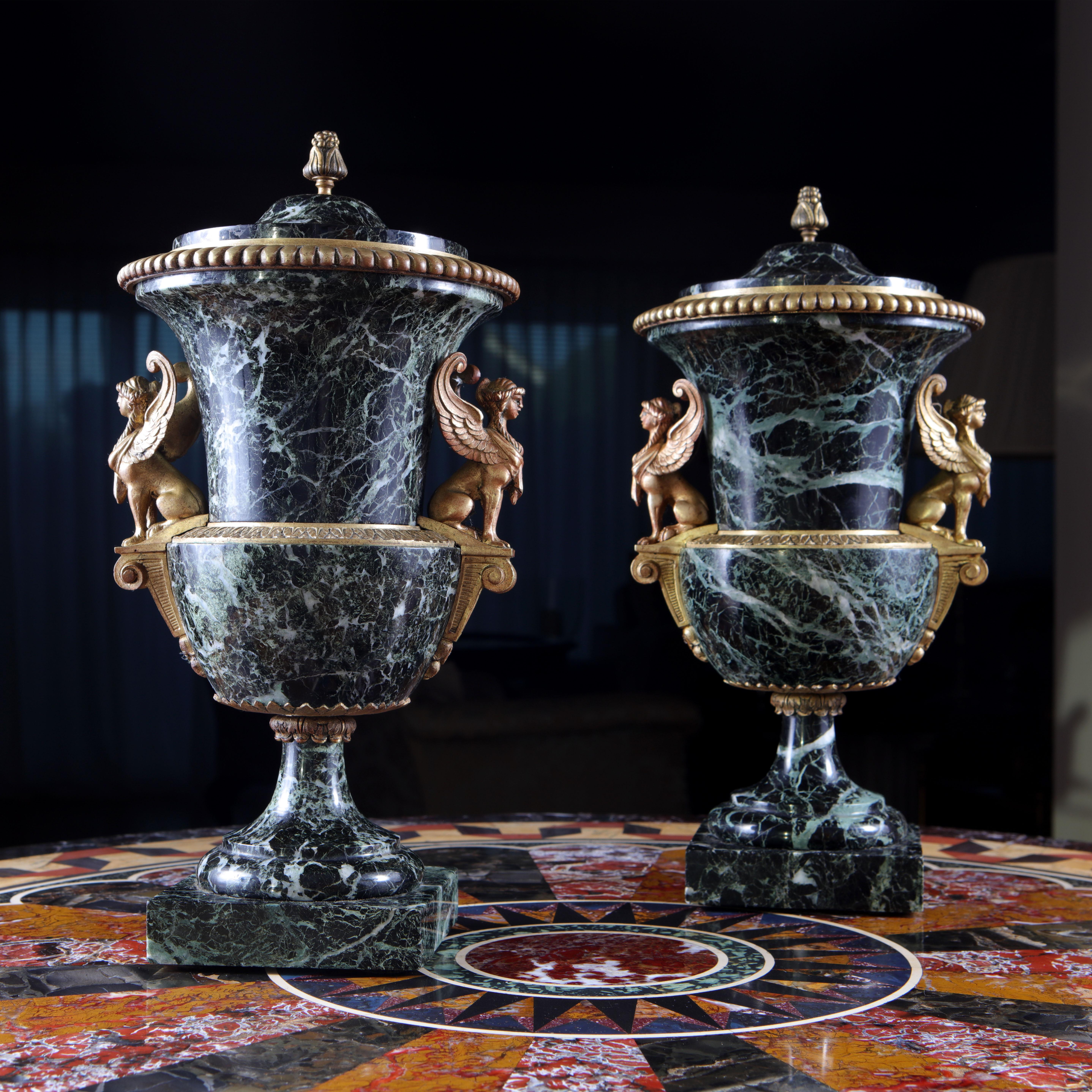 Pair of Campagna form green marble urns with lids, mounted with ormolu bronzes of Egyptian inspired sphinxes.