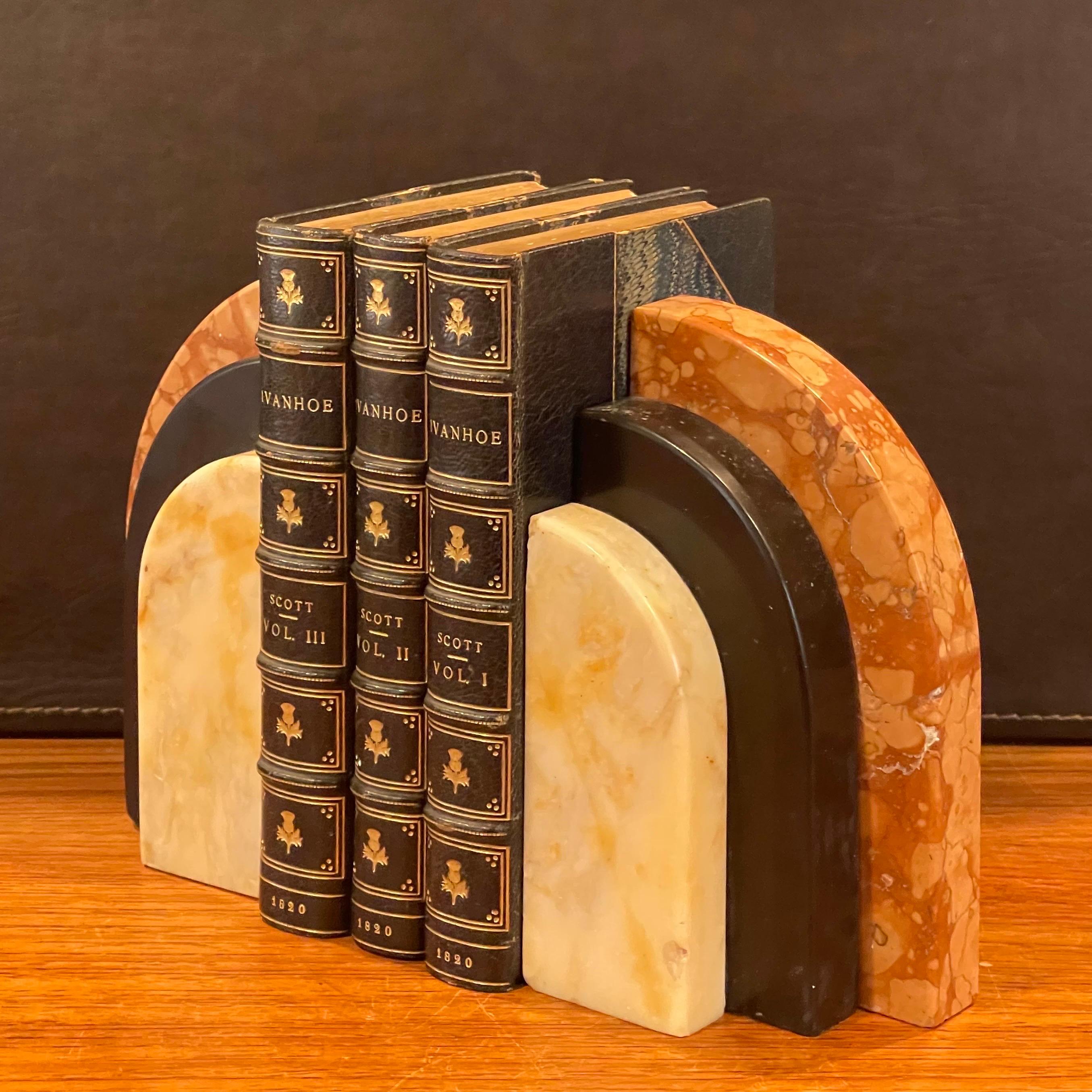 Fabulous heavy pair of cut marble arched Art Deco bookends, circa 1930s. They are in original condition with a Fine patina and some surface scratches and small chips (please see pictures); the pair measures 8