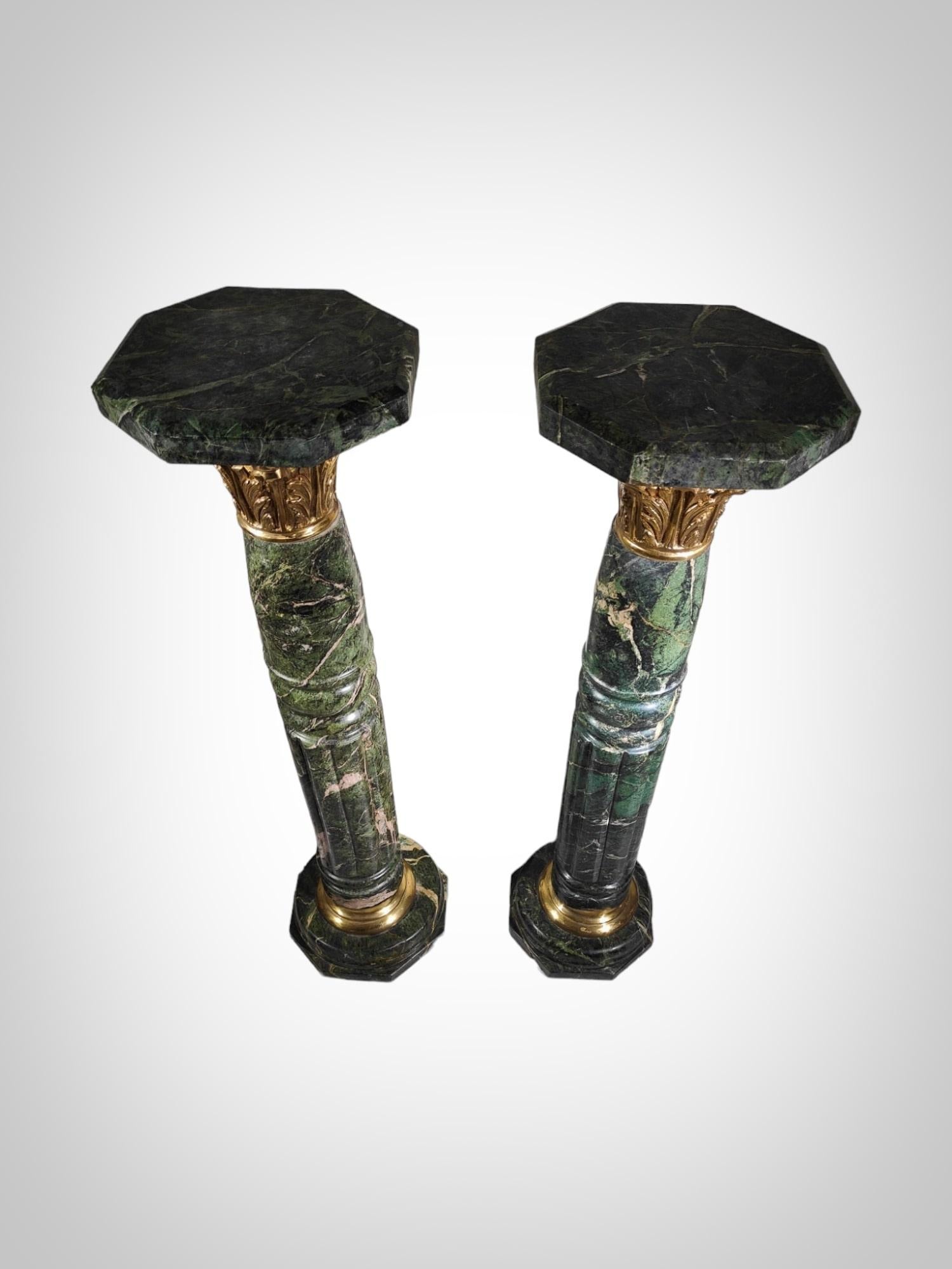 Immerse yourself in timeless elegance with this remarkable pair of 1950s marble columns, a classic example featuring veined green marble and enhanced with bronze mounts. These columns can also serve as pedestals, adding a touch of sophistication to