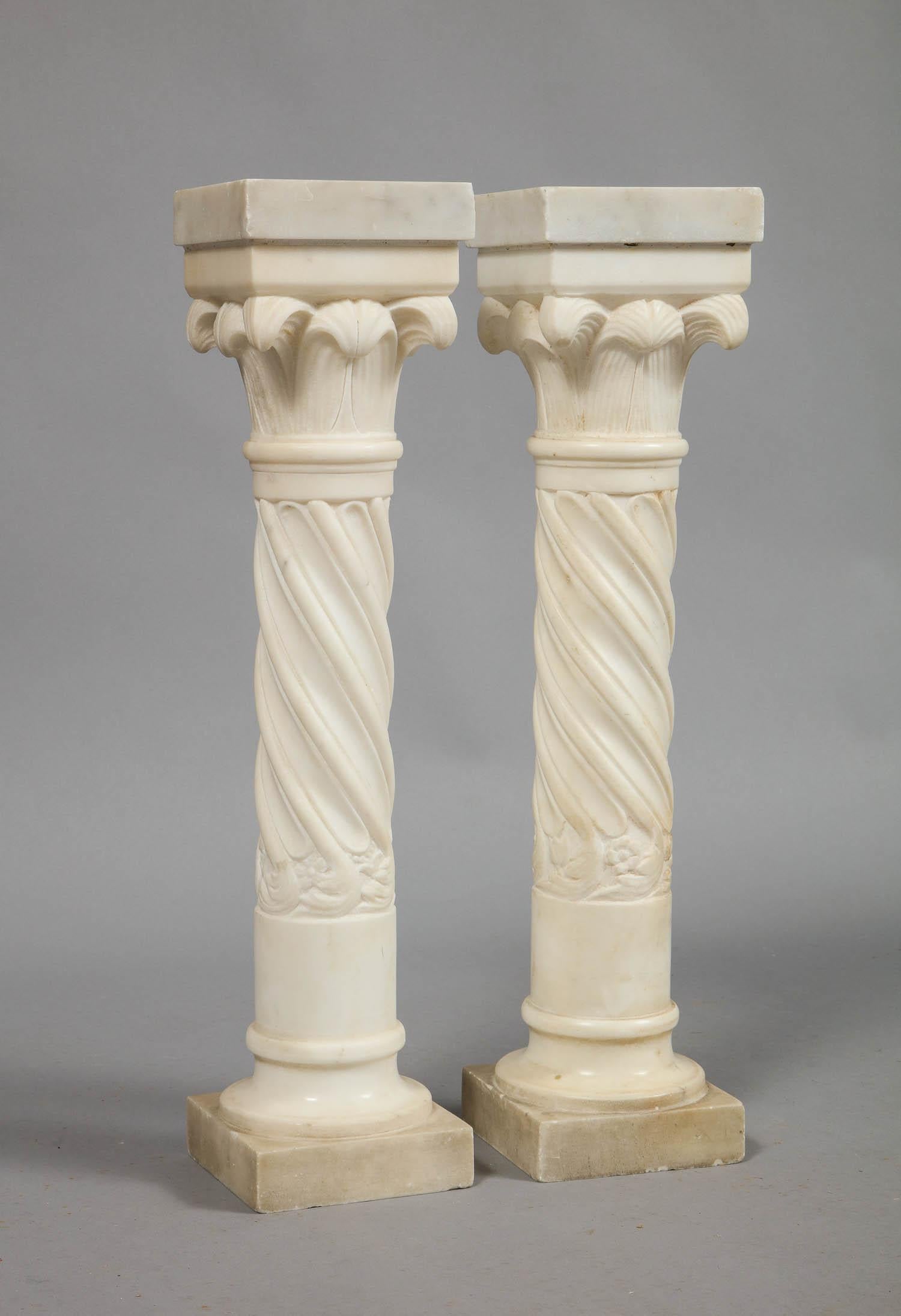 A pair of white marble columns with twist shafts and leafed capitals, perhaps Stanford White or Addison Meisner. For use as decorative accessories, or can be converted to lamps.