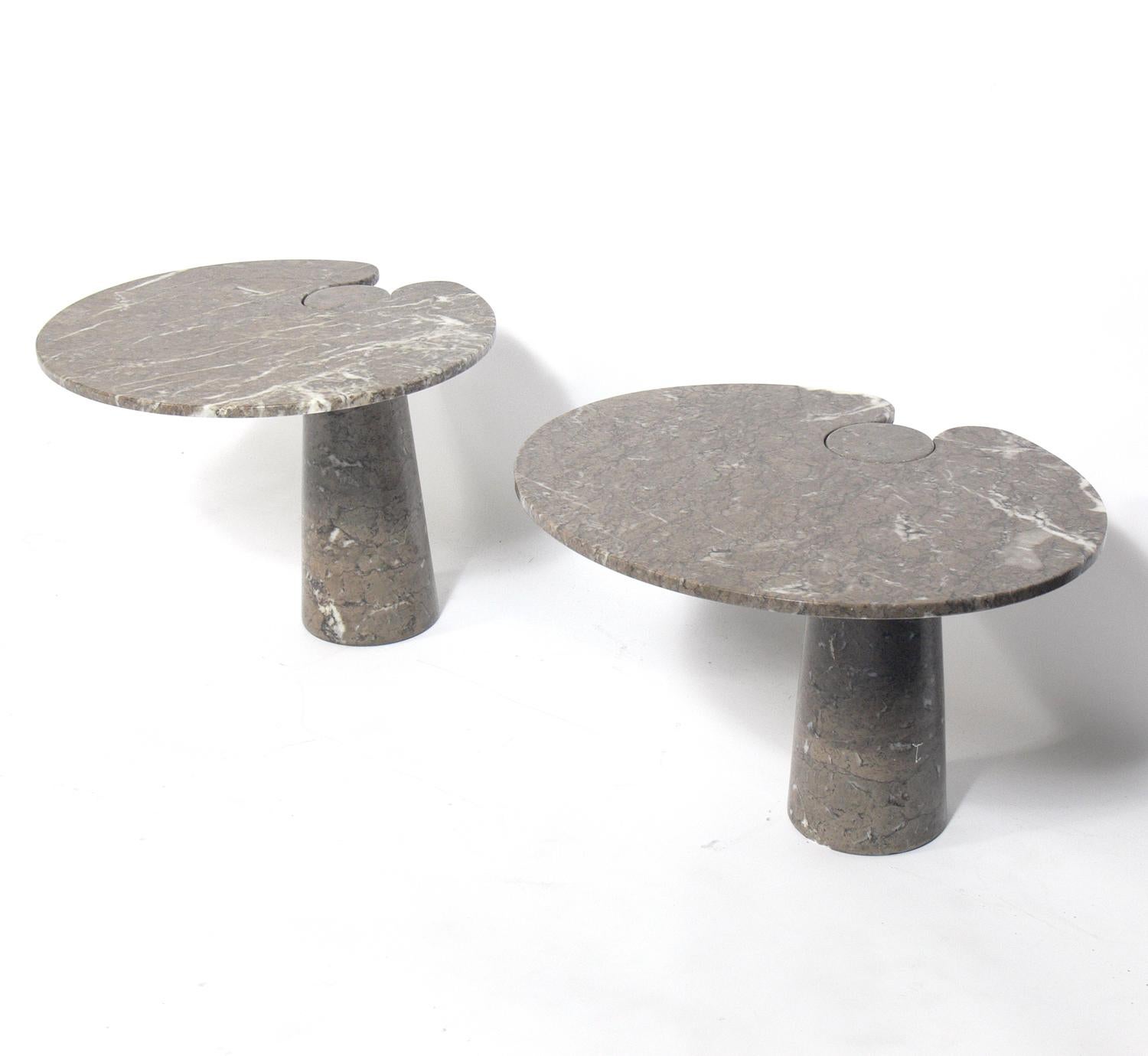 Pair of sculptural marble end tables in the manner of Angelo Mangiarotti, Italy, circa 1970s. These tables are made from polished Grigio Mondragone marble, with a taupe-grey field and black and white veining. Safety note: These tables are tippy.