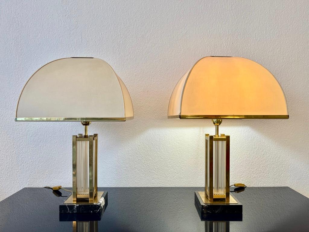 Vintage elegant pair of table lamps by Romeo Rega, Italy ca. 1970's
Black marble base, brass structure with vetical glass rods inside. Originals silk dome shades with brass trims.
Good vintage condition. 2 marks on the back of one shade of one lamp