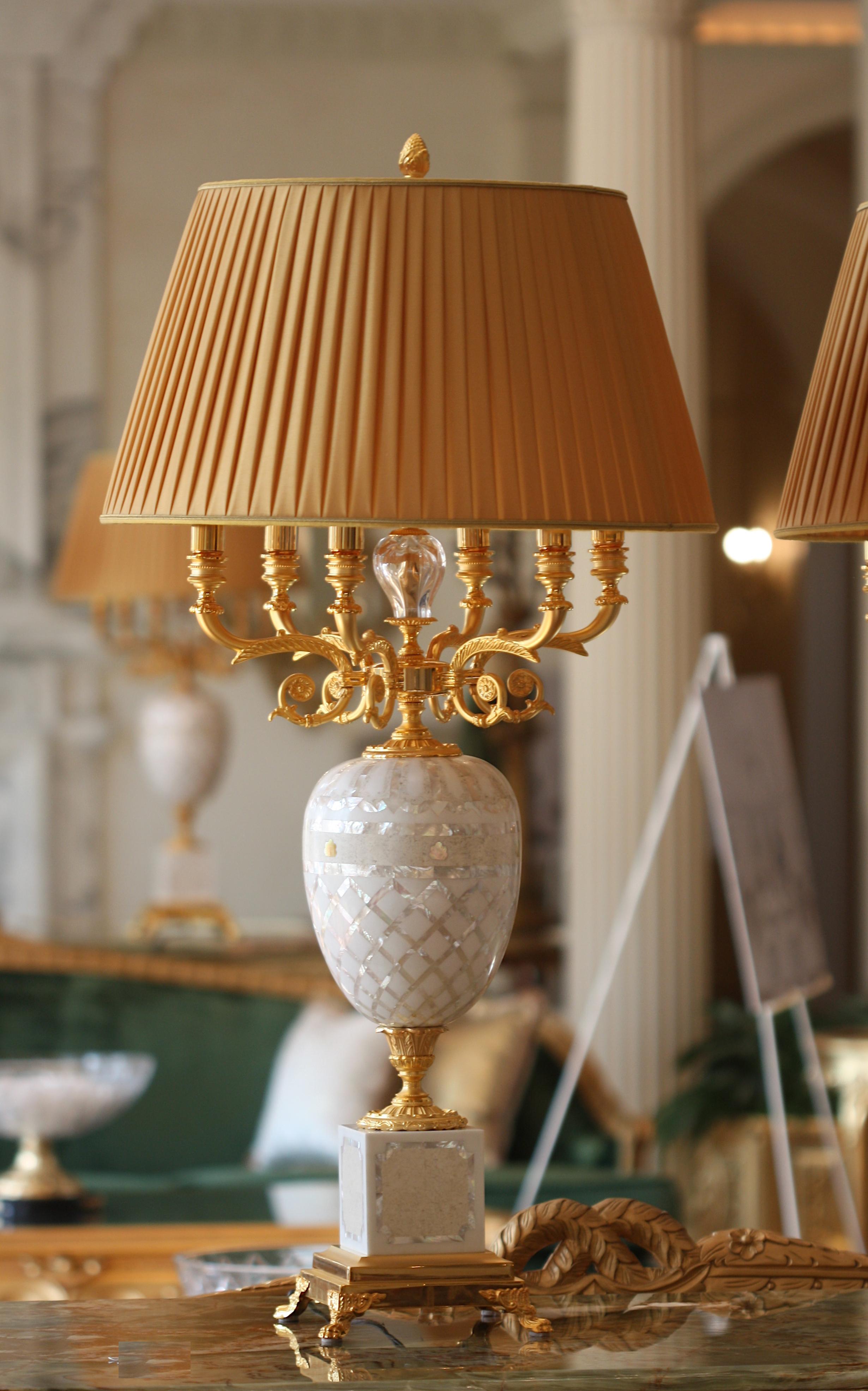 
Pair of Marble, Mother-of-Pearl Veneered, and Gilt Bronze Six-Light Candelabra mounted as Lamps
Each ovoid body with pieces of veneers, on a square base with four paw feet, supporting gilt bronze arms, electrified.
Height 45 in., Width 17 in.,