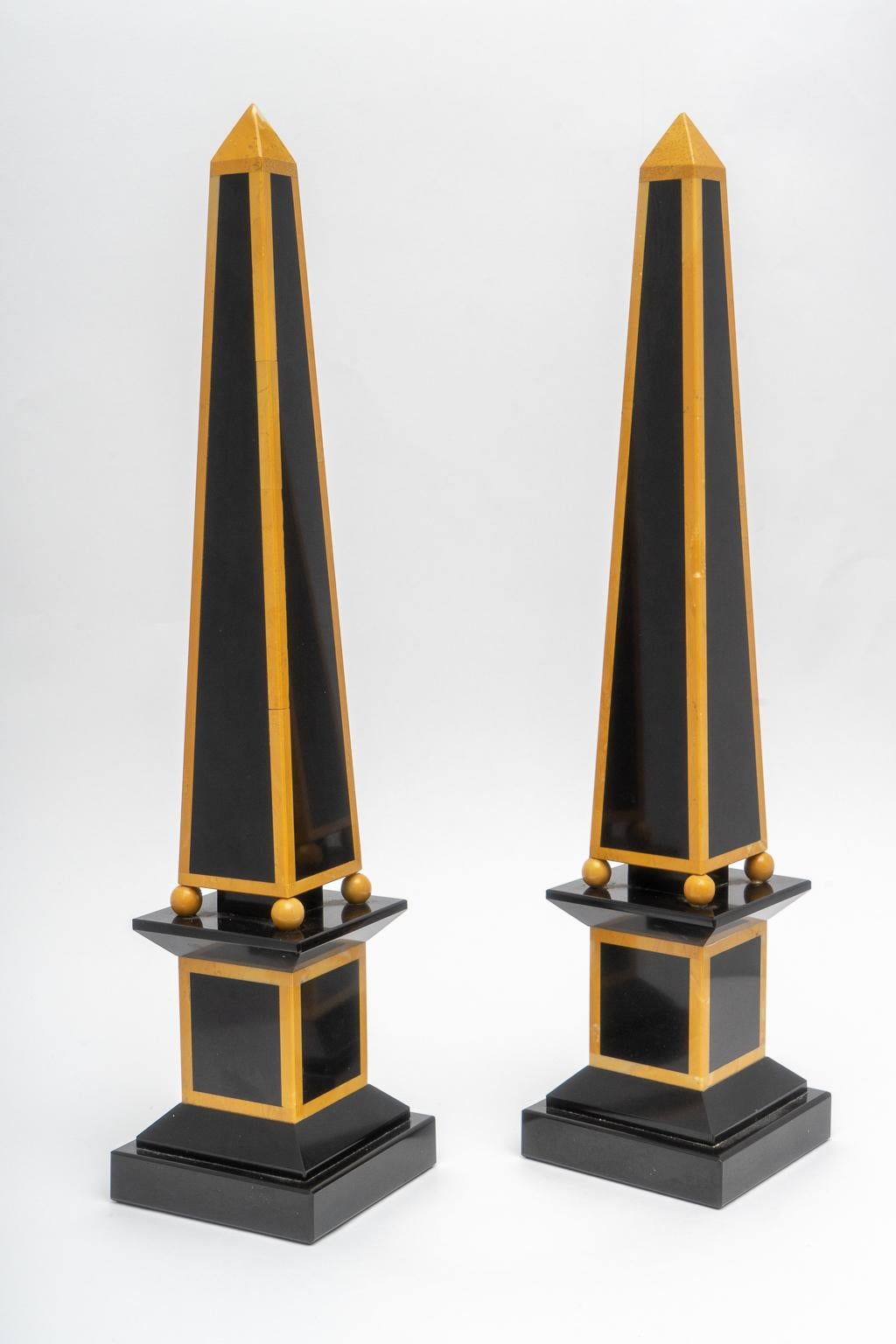 This stylish set of Egyptian Revival marble obelisks date to the 1920s-1930s and were acquired from a Palm Beach estate. The pieces are fabricated in black and mustard colored marbles.