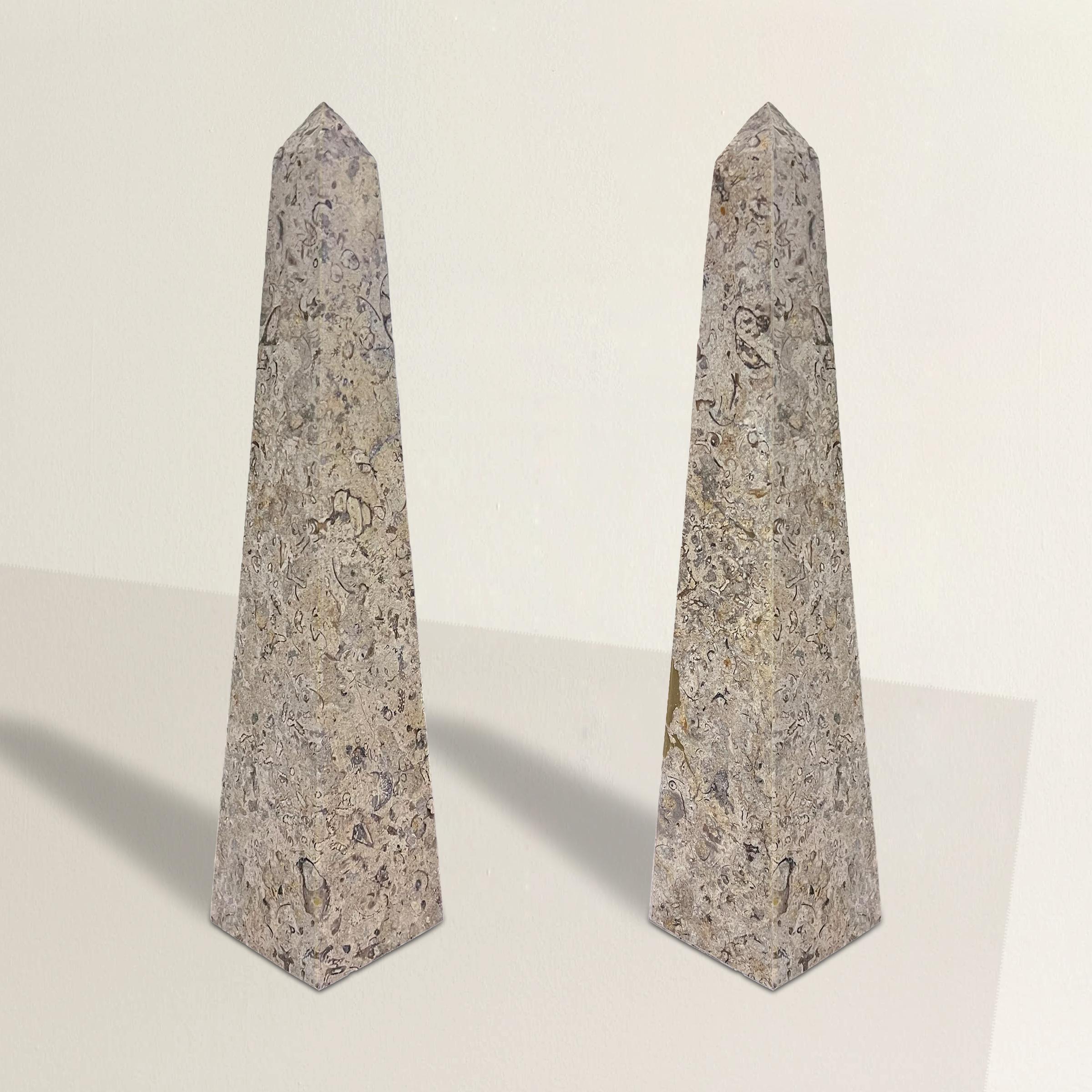 This pair of marble obelisks stands as elegant tributes to the enduring allure of ancient art. Drawing inspiration from the monumental obelisks of ancient Egypt and Rome, these exquisite pieces pay homage to a rich history. The obelisk, a symbol of