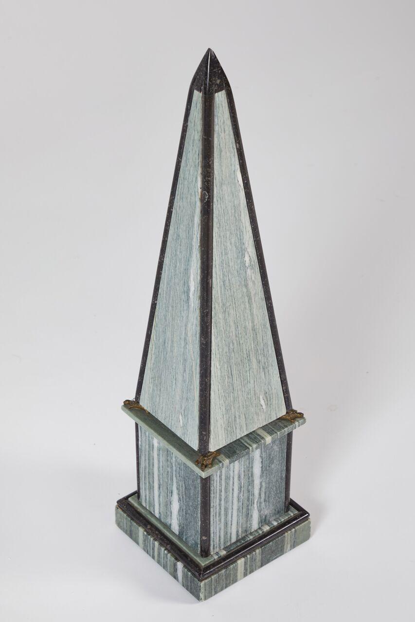 Pair of gray veined and black marble obelisks, of typical form; the obelisk supported by four turtles in gilded bronze.
France, circa 1900.