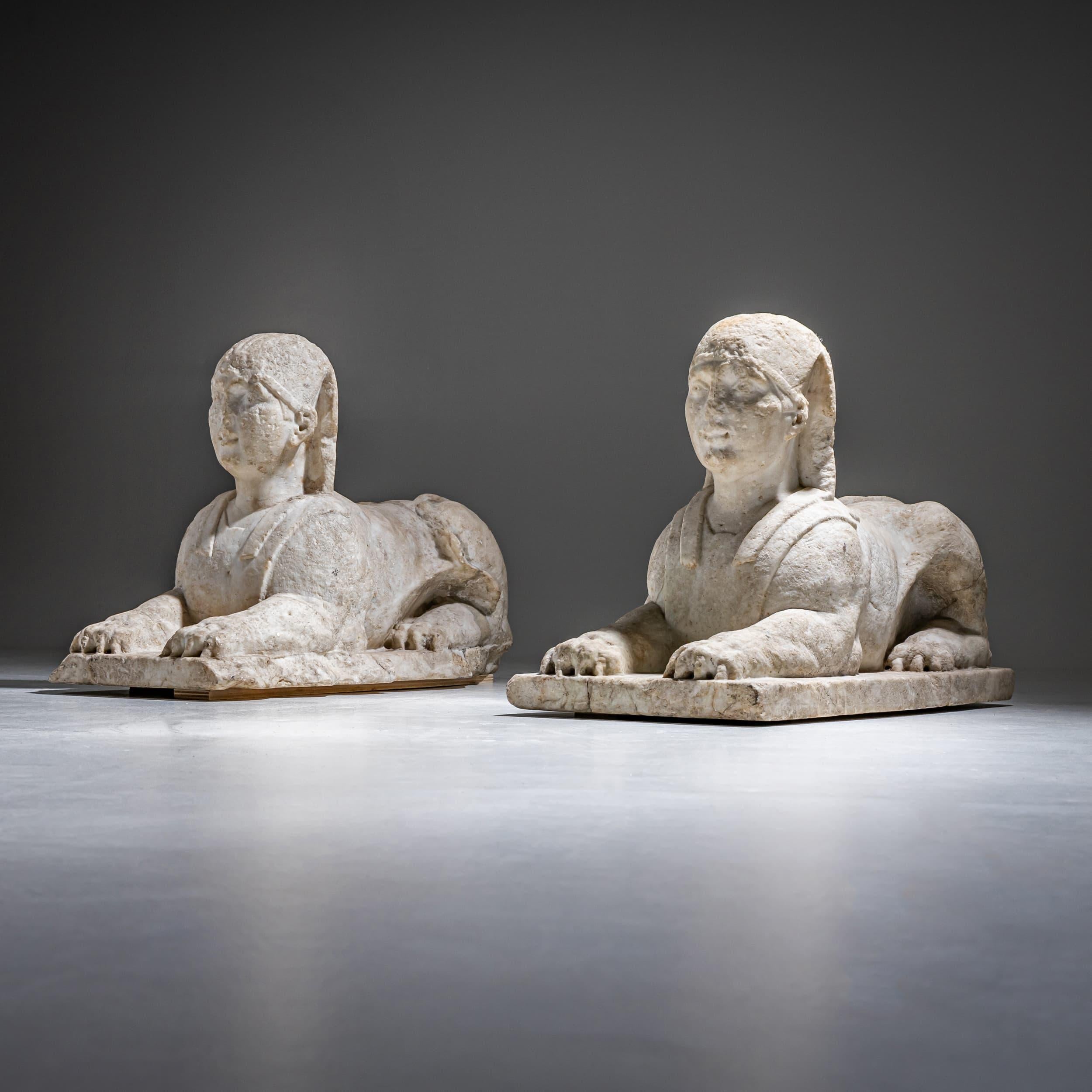 Pair of sphinxes in white marble with weathering traces, preserved with remnants of their original floor slabs. The cut edges suggest they once served as flanking supports at ground level. Italian school.
Export license No. 19769 available.