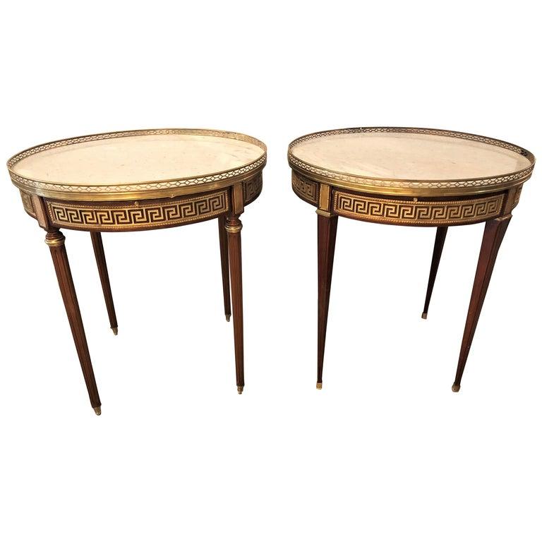 Pair of marble-top Greek key Bouiliotte tables / end mahogany double drawers.
A pair of marble-top Greek key Bouillotte or end tables in mahogany with double drawers and pull-out slides. Each bronze sabot leading to a group of tapering legs