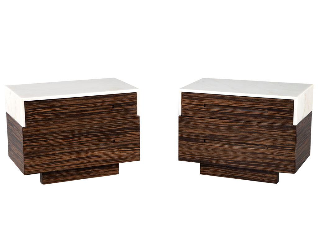 Pair of marble top macassar end tables. American, circa 1980’s. Custom made art deco inspired tables with a modern flare. Featuring beautiful Italian marble tops with unique detail veining. Rich macassar woods complete the design with magnificent
