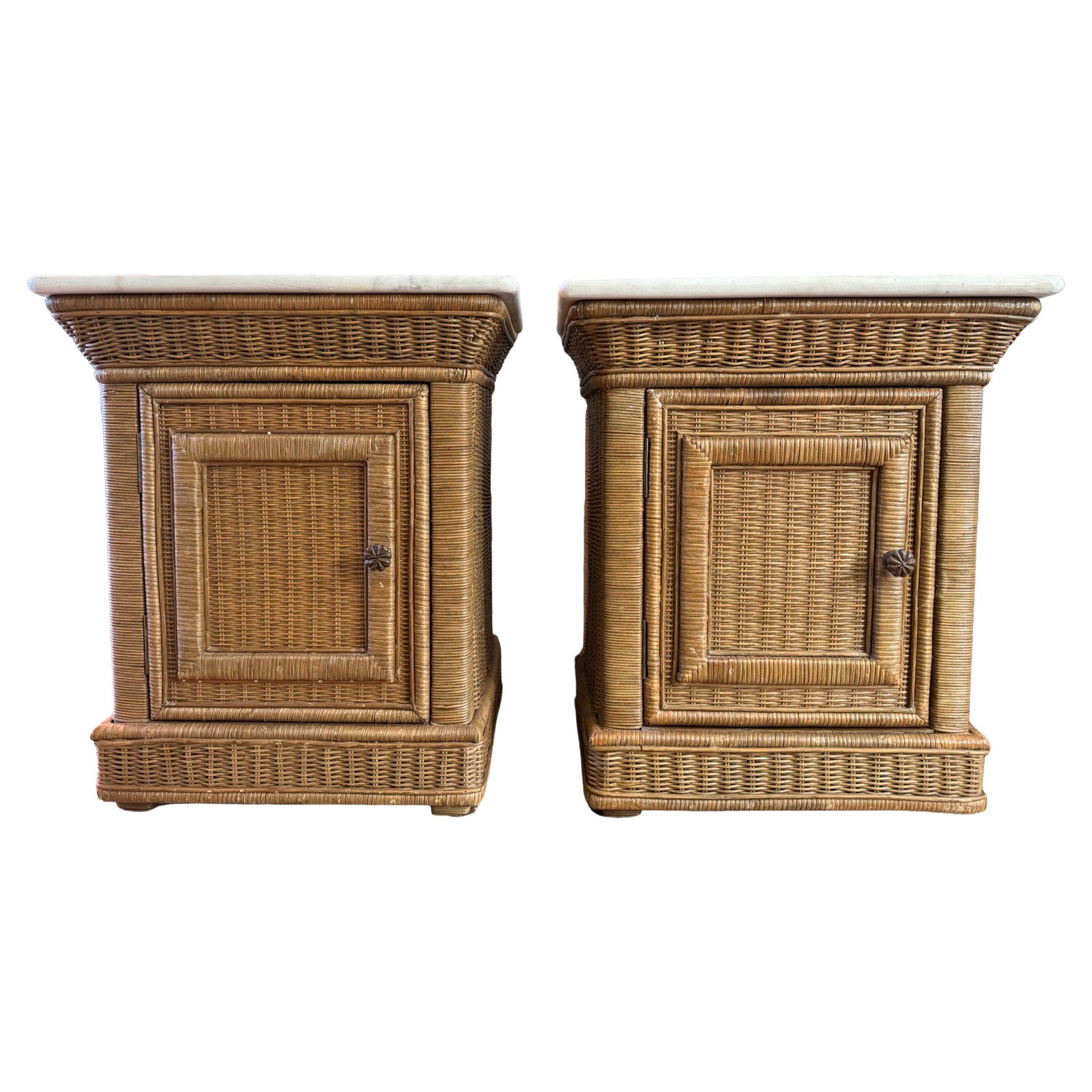 Introducing a charming pair of wicker end tables or nightstands that effortlessly blend functionality with elegance. Each table features a stunning white honed Calacatta marble top, which adds a touch of luxury and sophistication. The natural wicker