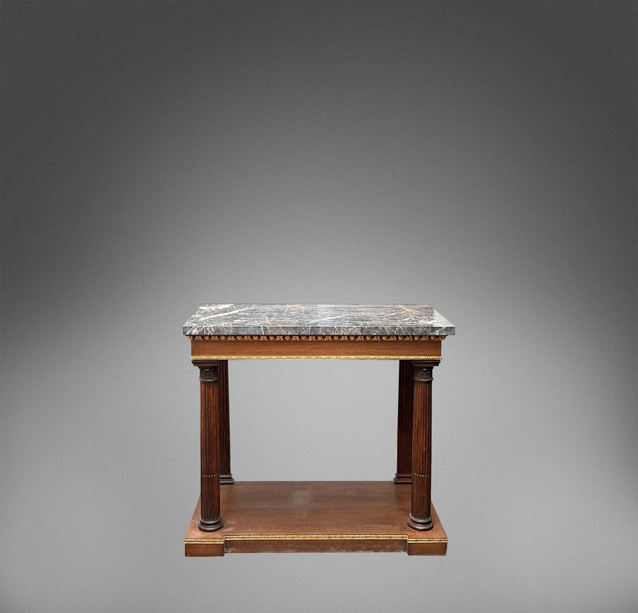 A powerful and regal pair of oak Corinthian column console tables with antique Ashburton marble tops.

The tables were reconstructed from early 19th century Corinthian column legs and pilasters, giving them a deep history. 