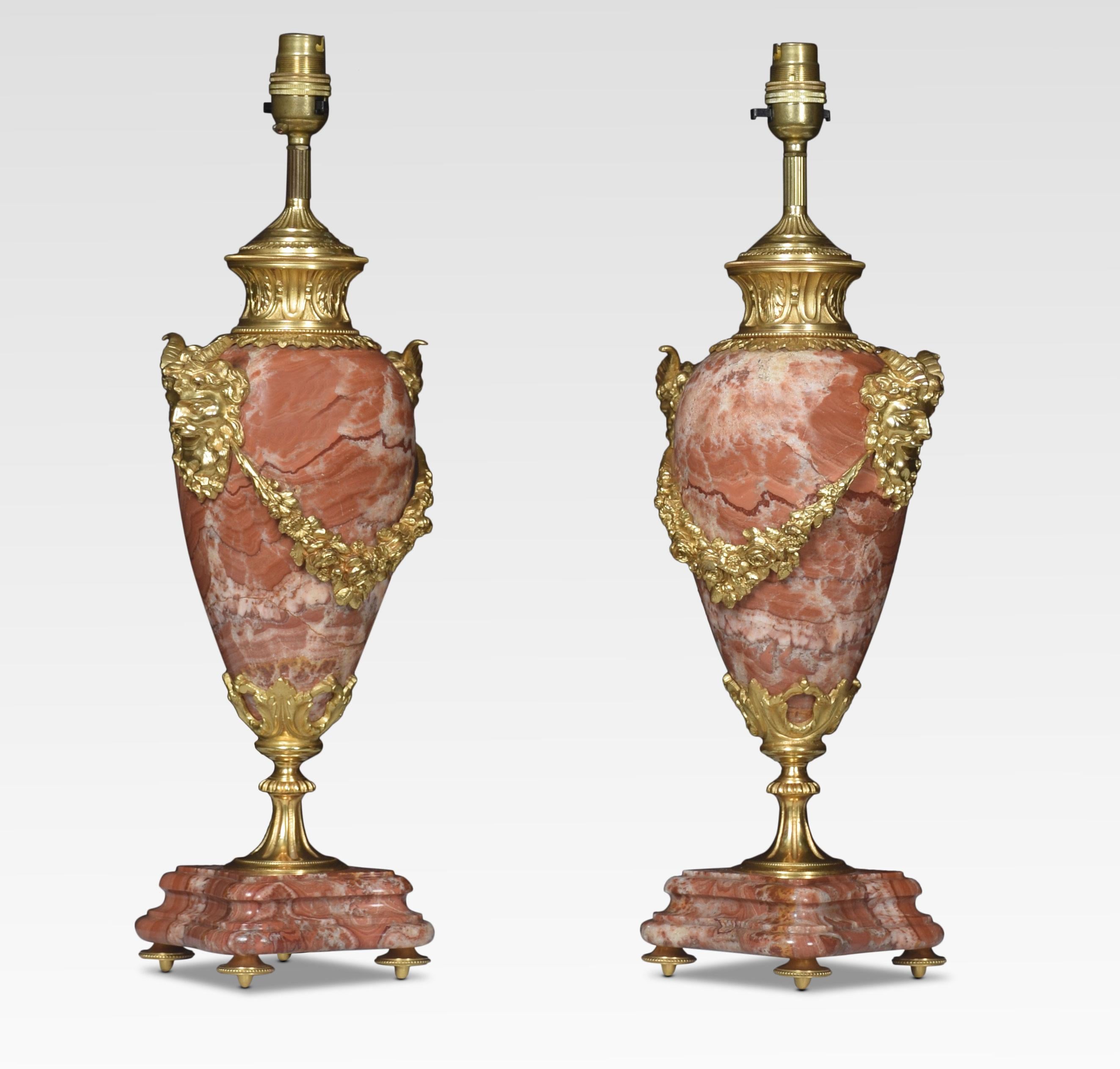 Pair of gilt brass mounted rouge marble table lamps with satyr mask handles and floral swags raised up on shaped stepped bases. Together with silk shades.
(the lamps have been re-wired).
Dimensions of Lamps without shades
Height 19.5