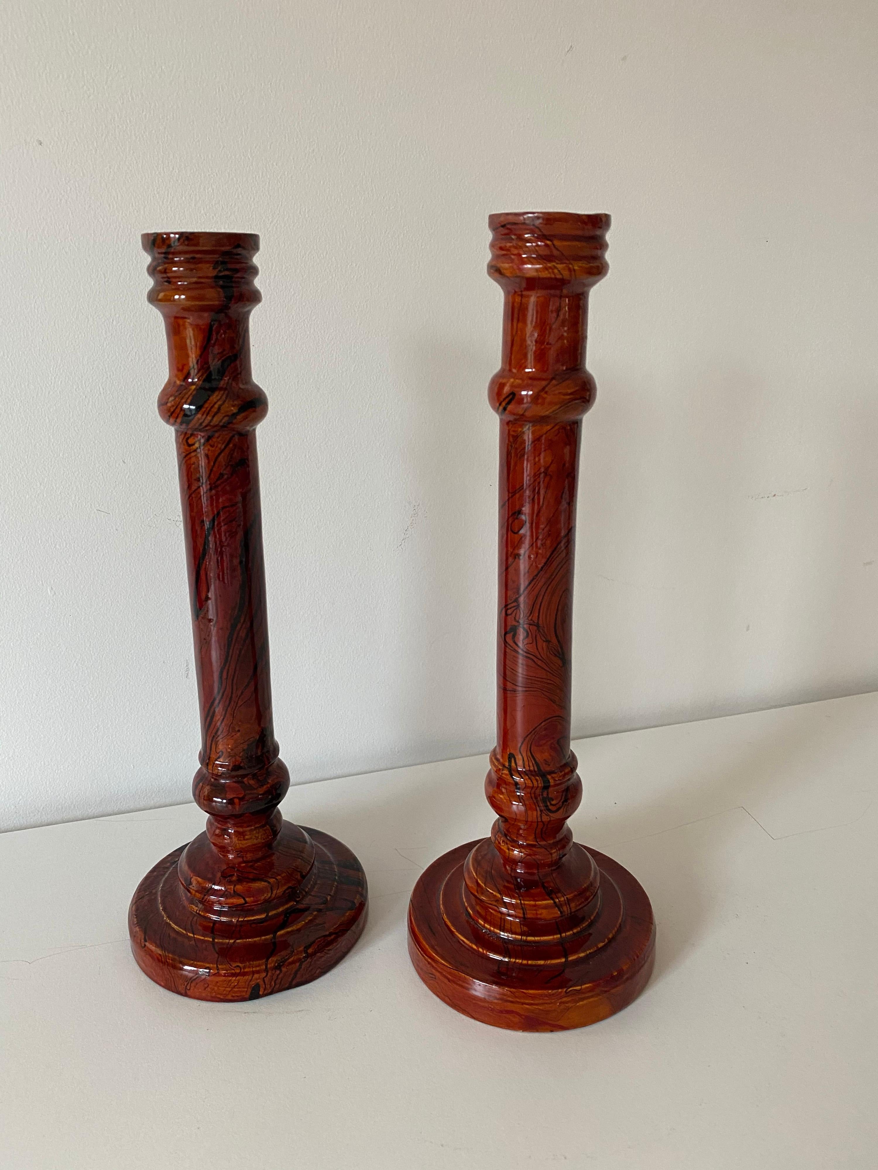 A pair of vintage marbled wood candlesticks.