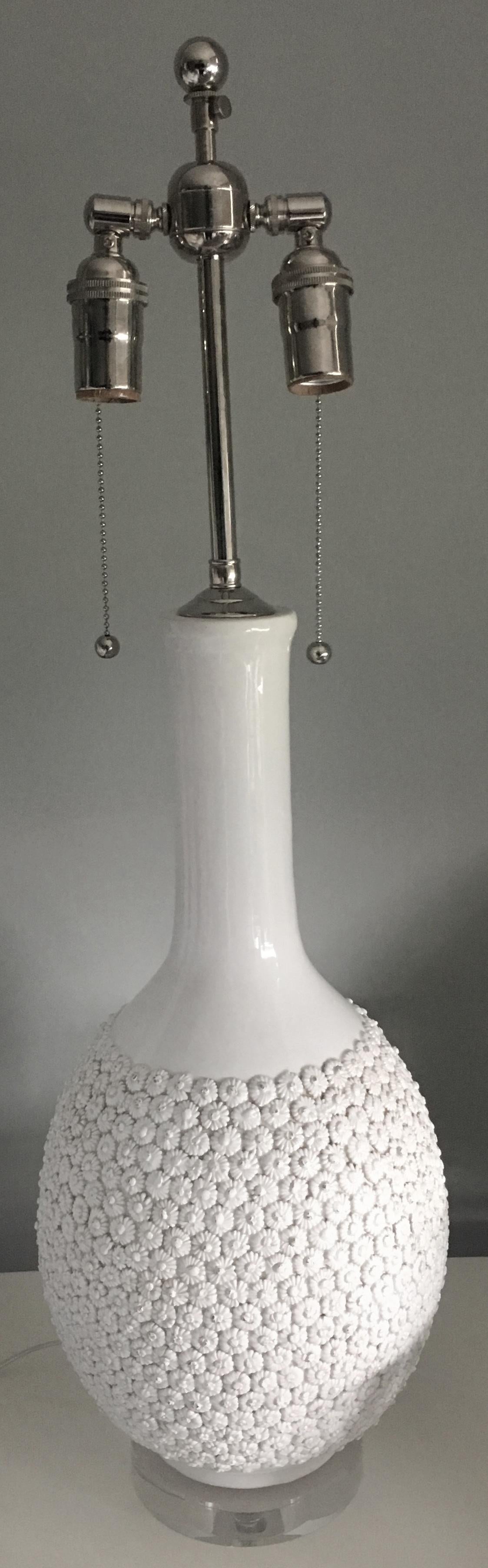 Pair of Mabro Blanc de Chien flower lamps. White ceramic design with all over raised flower detailing. New round Lucite bases. New polished nickel double cluster sockets. Newly wired with clear cord with side switch. Each lamp takes two standard