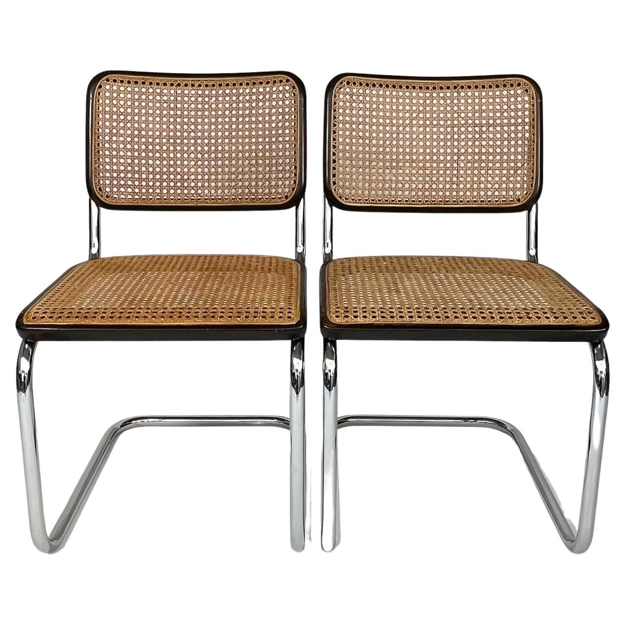 Pair of iconic Marcel Breuer S 32 chairs for Thonet, manufactured in 1984 by Thonet.

Made of chromed steel with dark brown lacquered wooden frames, original cane webbing.

Very good condition with signs of use and age, small break in the cane