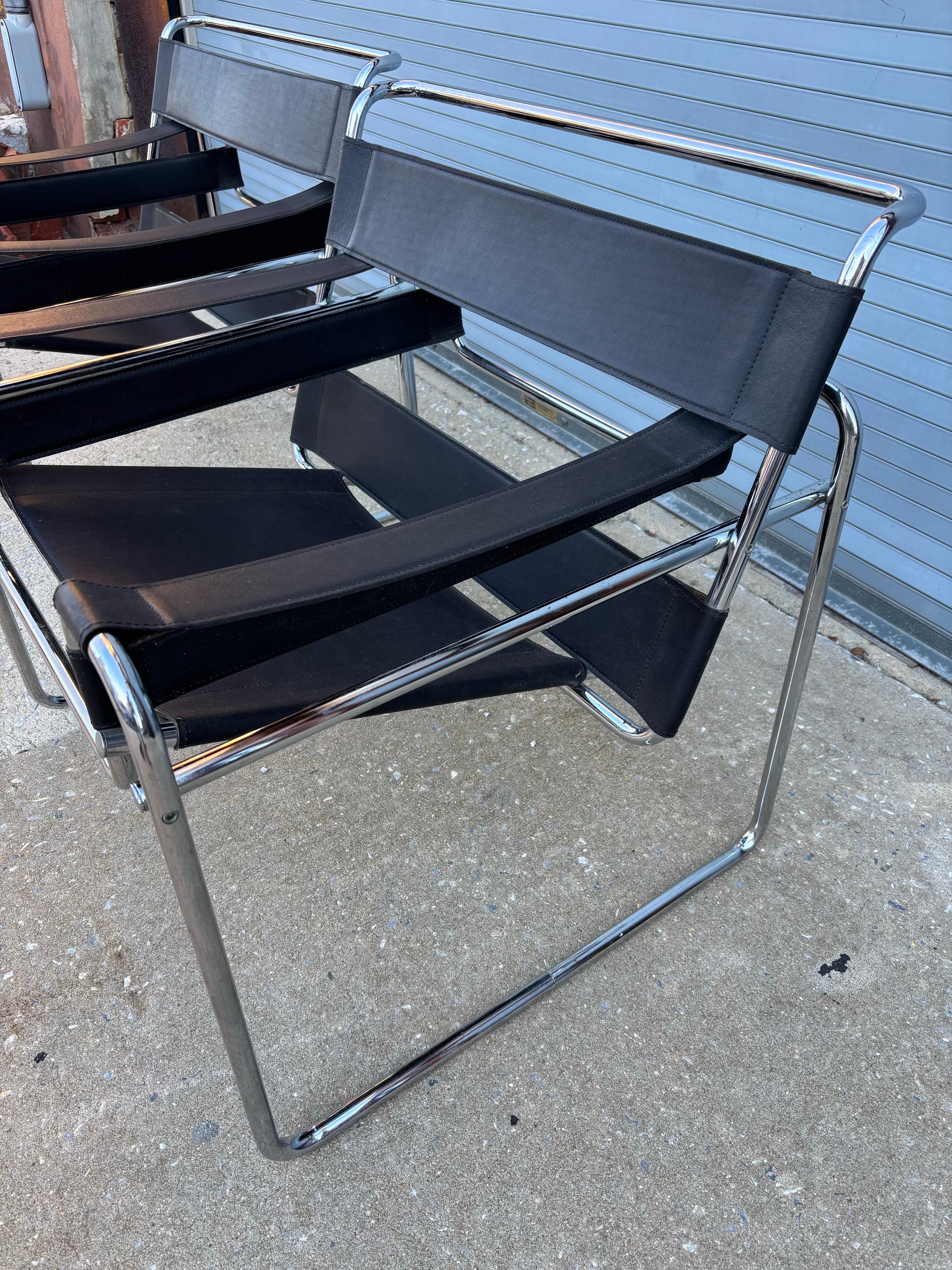 Pair of Marcel Breuer Black Leather Wassily Lounge Chairs.  Each have made in Italy Tags.  Would guess this pair dates to the mid-80's.  Overall presents very well!  Chrome cleaned up well and Leather looks pretty good as well.  No bad seams or