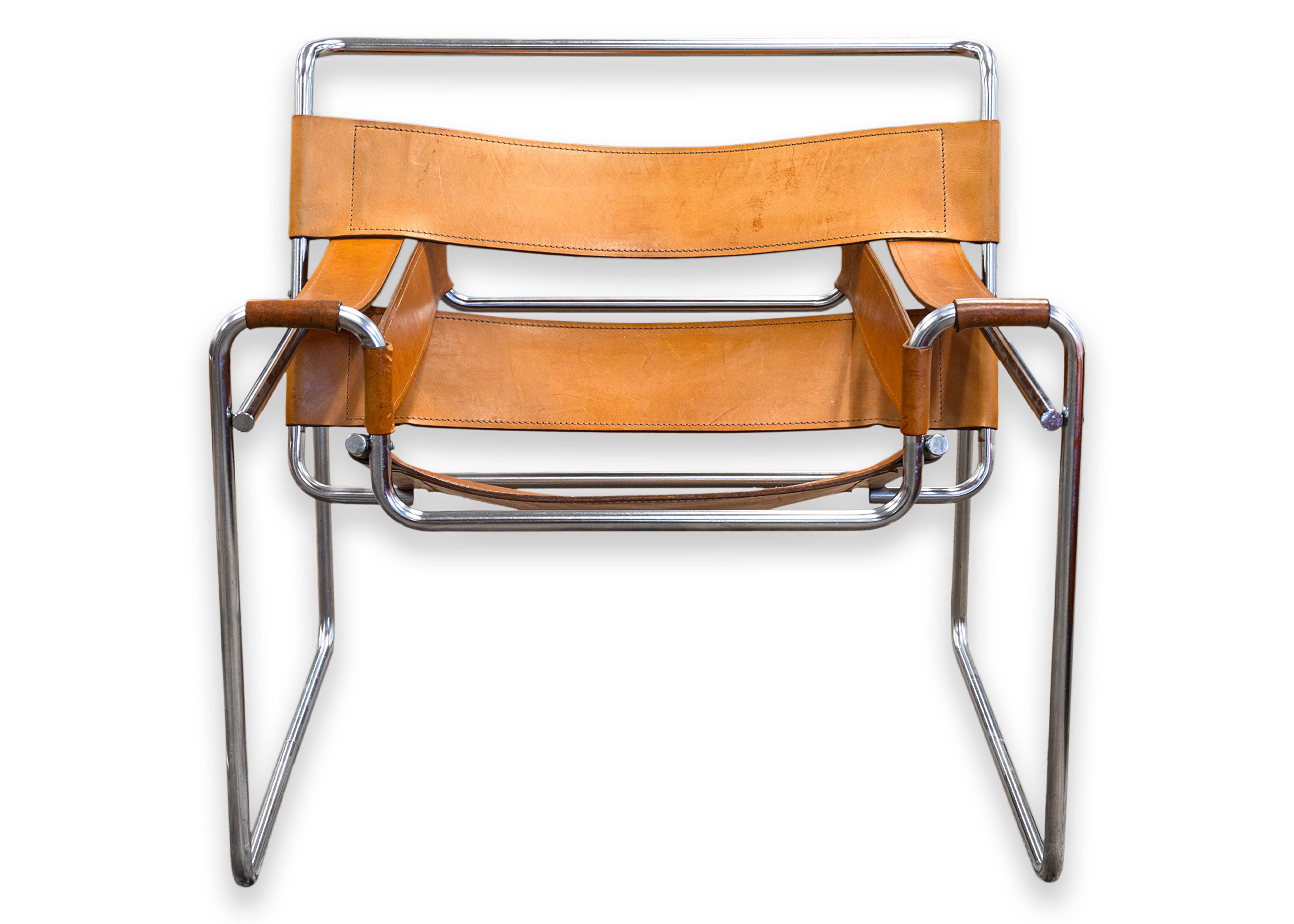 A pair of cognac Wassily chairs. This is a classic set of Wassily chairs designed by Marcel Breuer in 1925. Greatly inspired by the frames of bicycles, Breuer utilized bent tubular chrome for the frame. The frame is study, stylish, and sleek. All