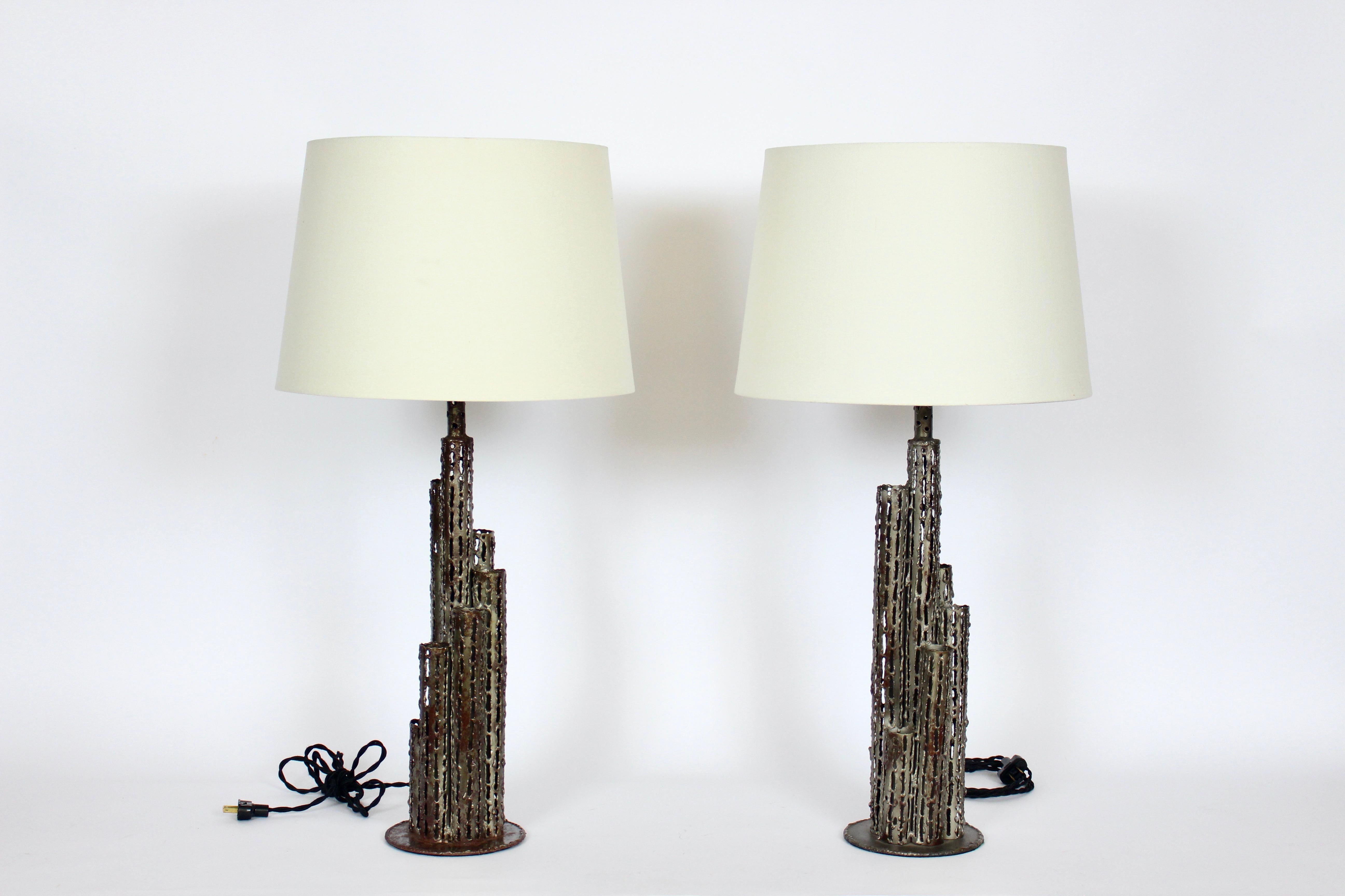 Tall pair of Marcello Fantoni handcrafted Torch Cut Steel Table Lamps, 1950's. Featuring open pierced, welded and sealed cylindrical pipe type forms with Nickel, Silver coloration and Verdigris touches throughout. Small footprint. Shades shown for