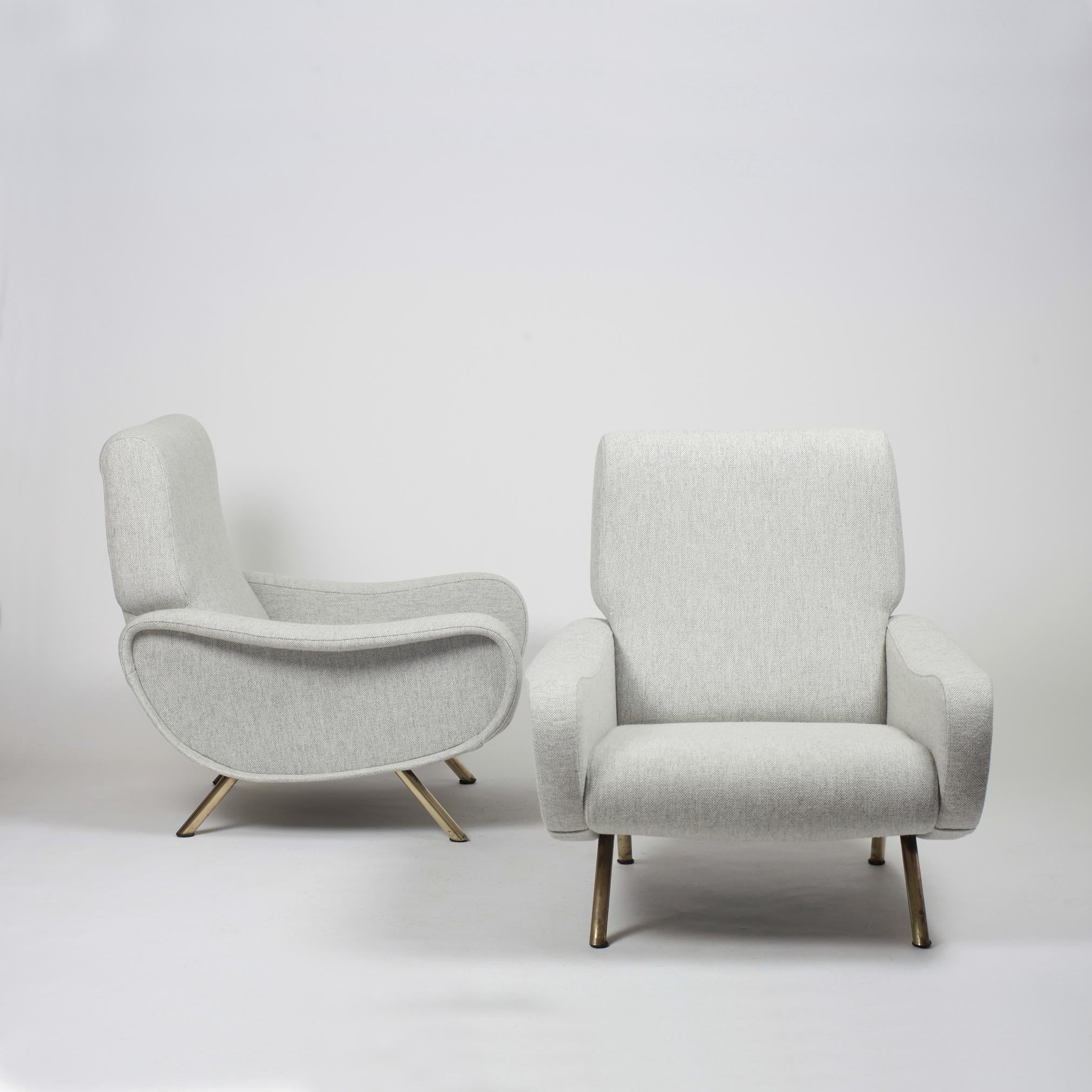 Pair of first edition Marco Zanuso lady chair for Arflex.
Fabric laced under the seat. Brass legs.
These chairs have been restored, as original, and reupholstered in a light grey Kvadrat woolen fabrics with new foam and straps.
Arflex label.