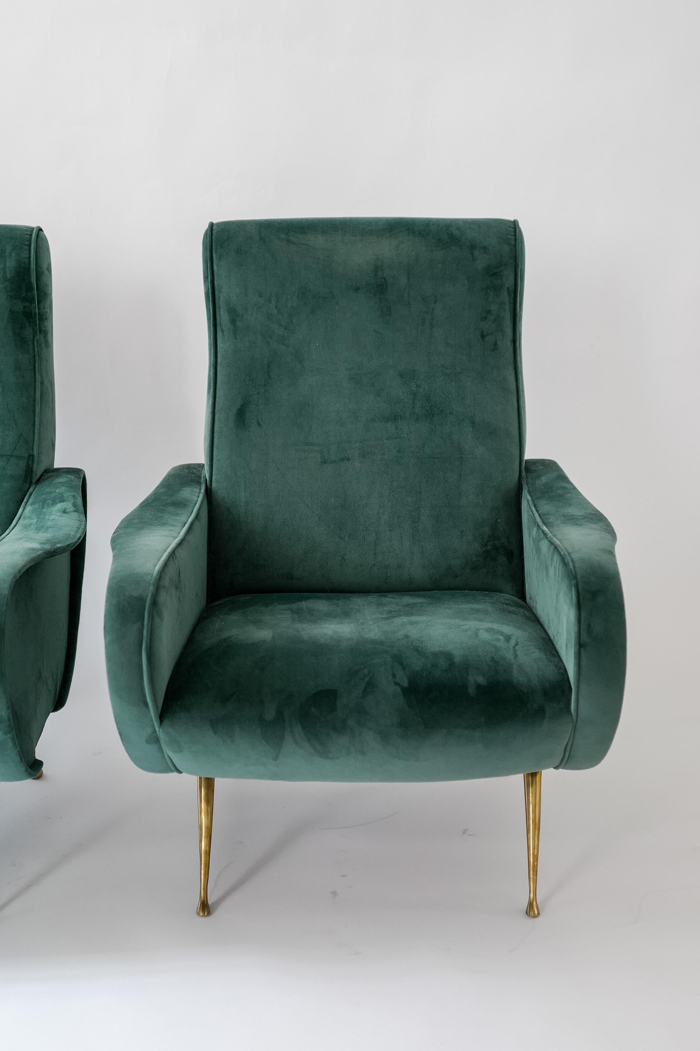 A pair of iconic Marco Zanuso lady chairs, Italy. Features brass feeting and newly upholstered in a rich green velvet. This shape is extremely comfortable and visually appealing.