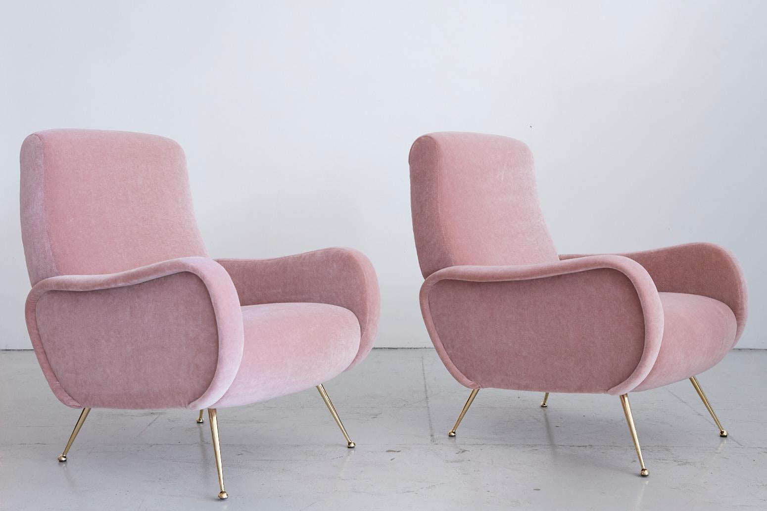 Stunning pair of Italian chairs in the style of the Marco Zanuso lady chair. Newly upholstered in a pink mohair with beautiful sculptural curved shape and newly polished brass tapered legs.