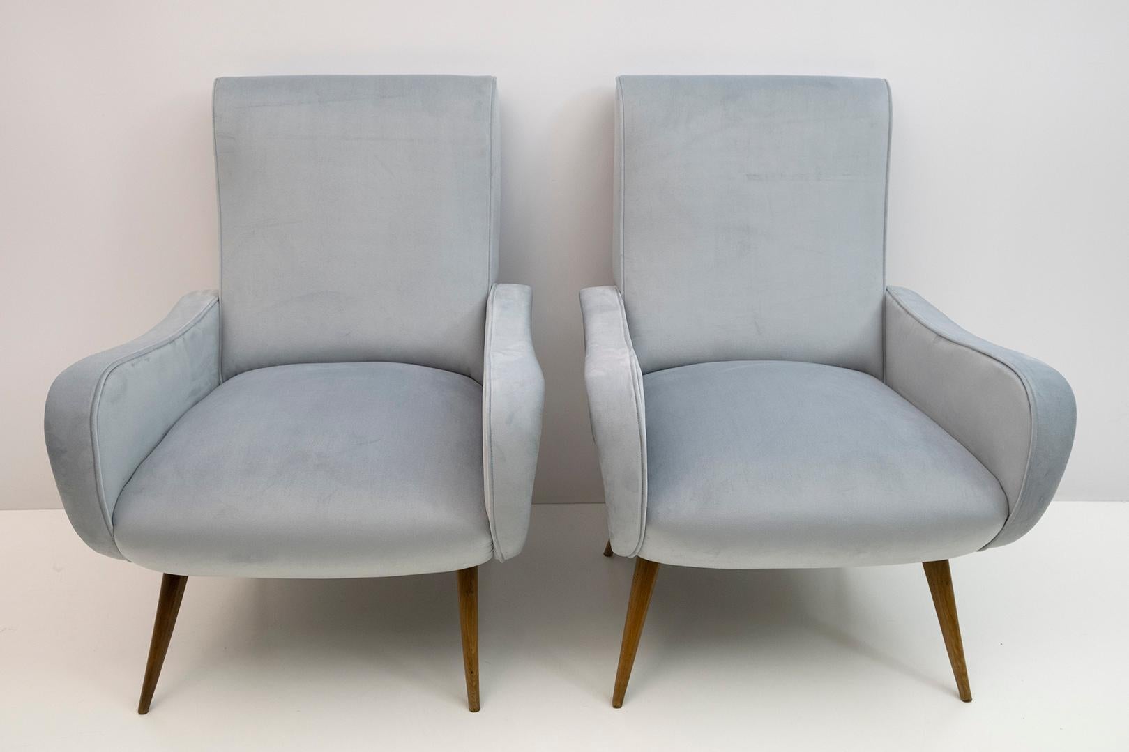 Pair of Marco Zanuso style armchairs. The armchairs have been restored and reupholstered in blue velvet, the feet are in beech wood.