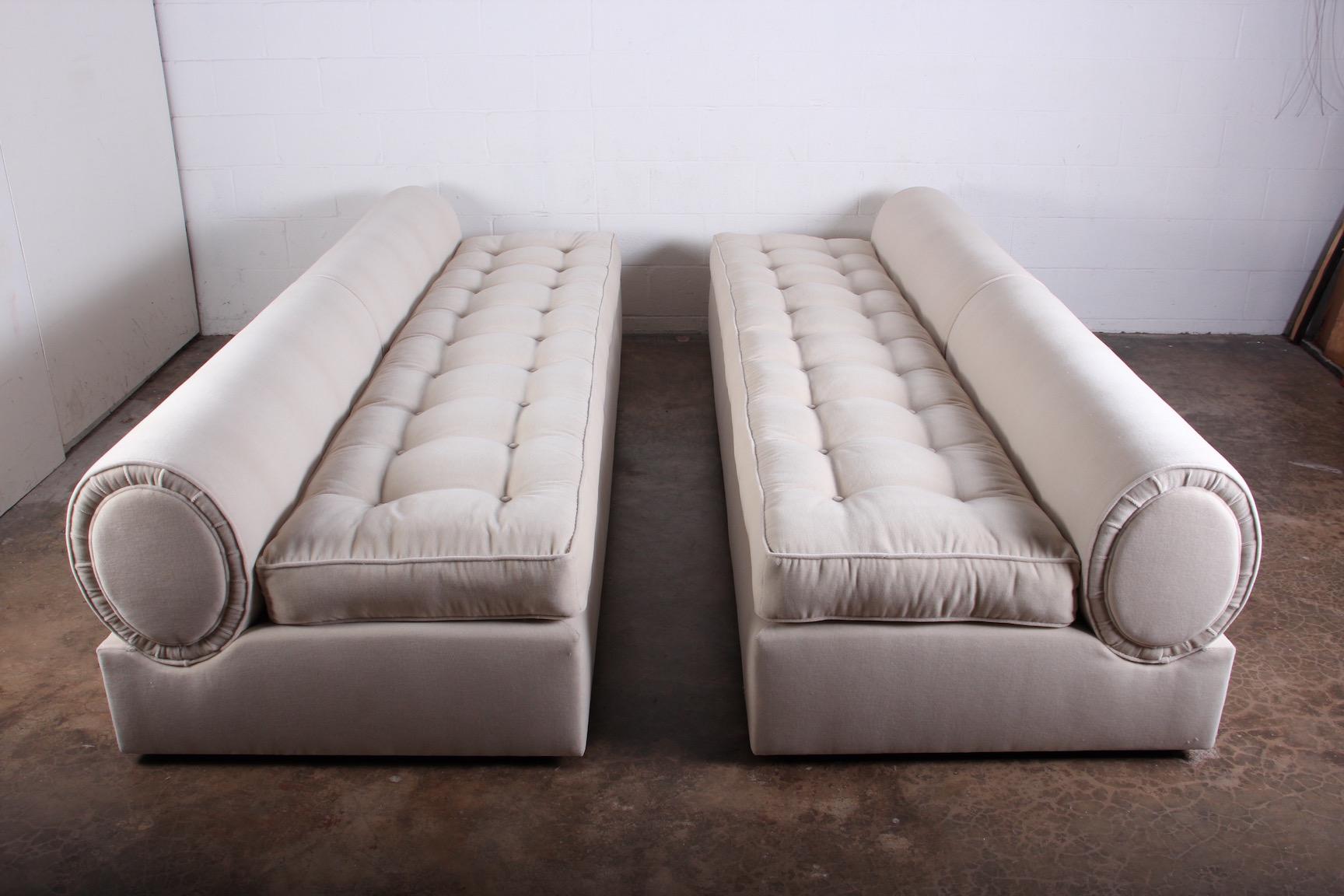 A matching pair of bolster back slipper sofas with down seat cushions designed by Marge Carson. Fully restored and upholstered in Donghia mohair.