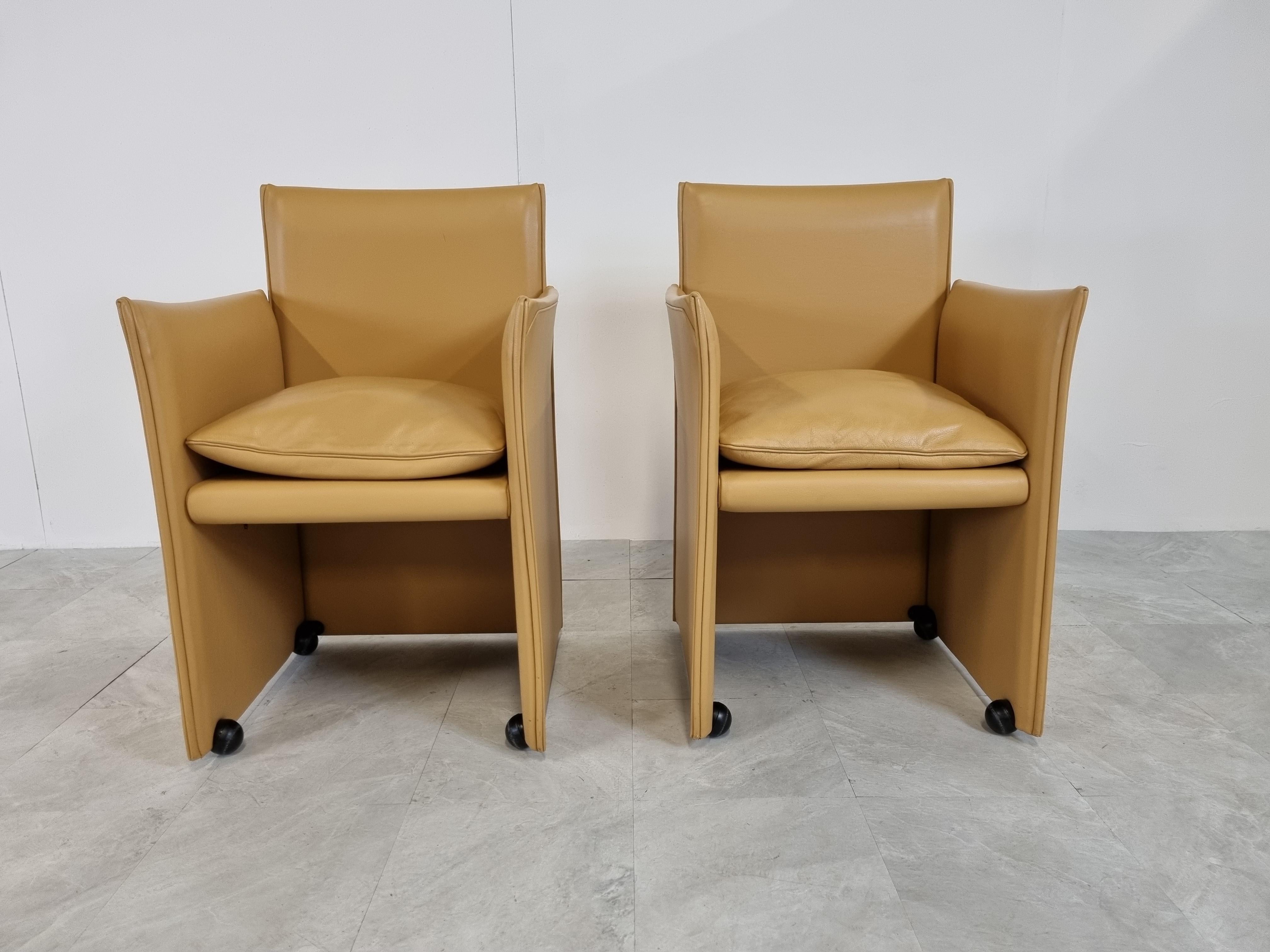 Pair of camel leather 401 break chairs designed by Mario Bellini and produced by Cassina.

The chairs are in perfect condition and are of a very high quality, as expected from Cassina furniture.

The chairs have 4 casters which make them glide