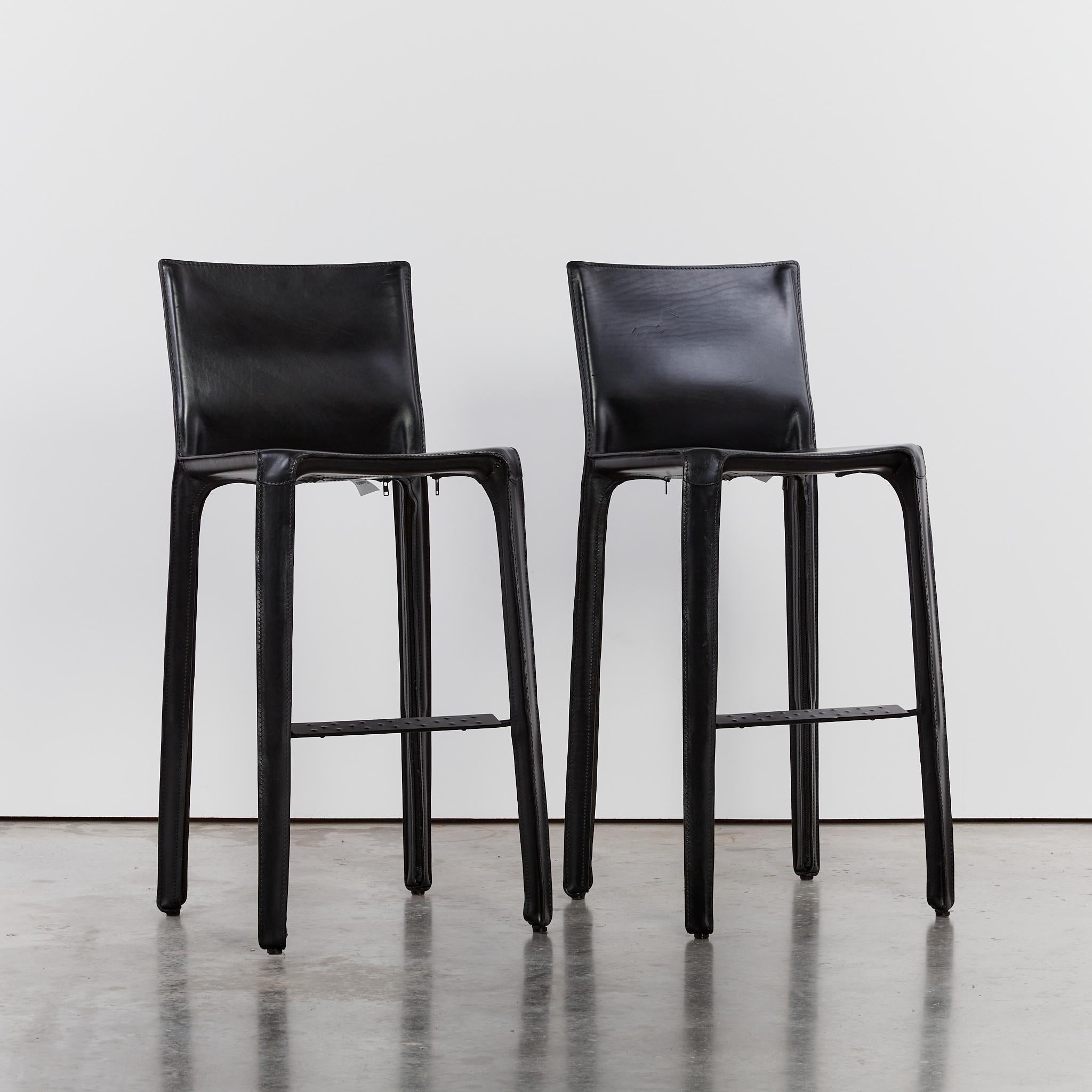 Mario Bellini CAB bar stools in black leather. Includes original labels and embossed logo on the base.

Made with a lengthy thinning process of the leather, the cut parts are stitched together, while the upholstery is hand-fitted to the steel