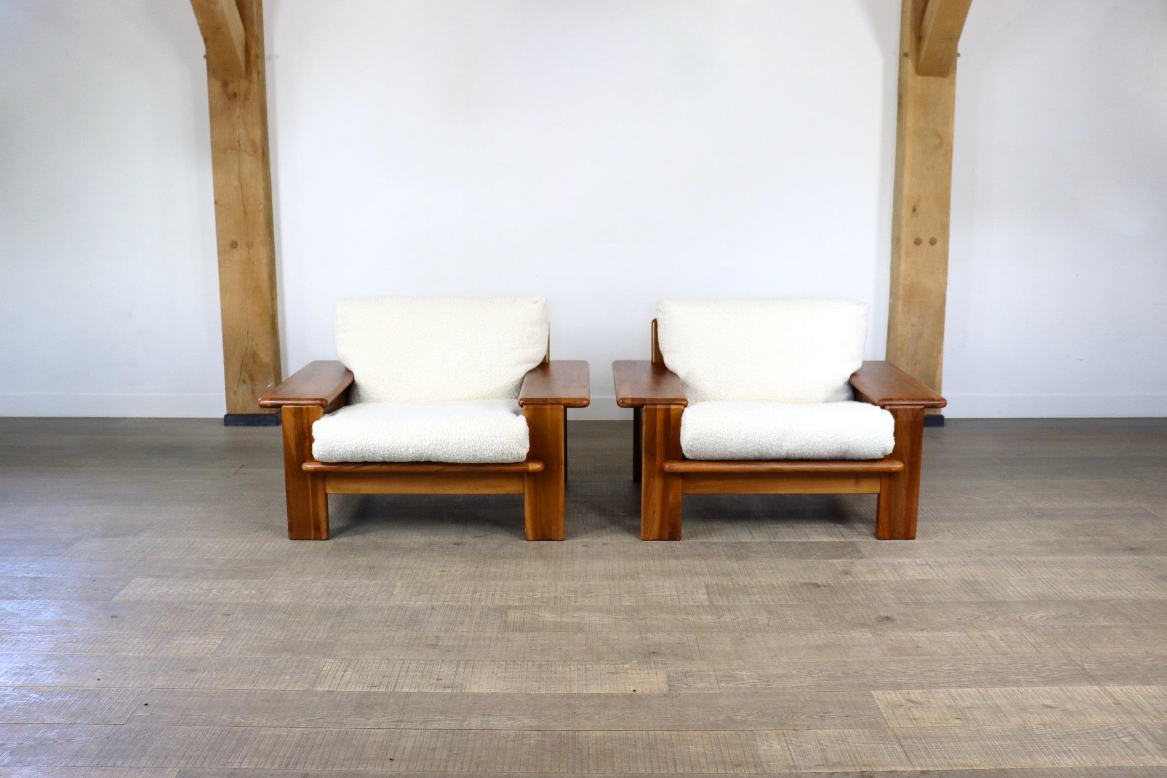 Incredible and rare pair of Mario Marenco Lounge chairs in solid walnut wood and bouclé cushions for Mobilgirgi, Italy 1970s. The large armrests give a luxurious feeling, complemented by the white bouclé cushions, which provide incredible comfort.