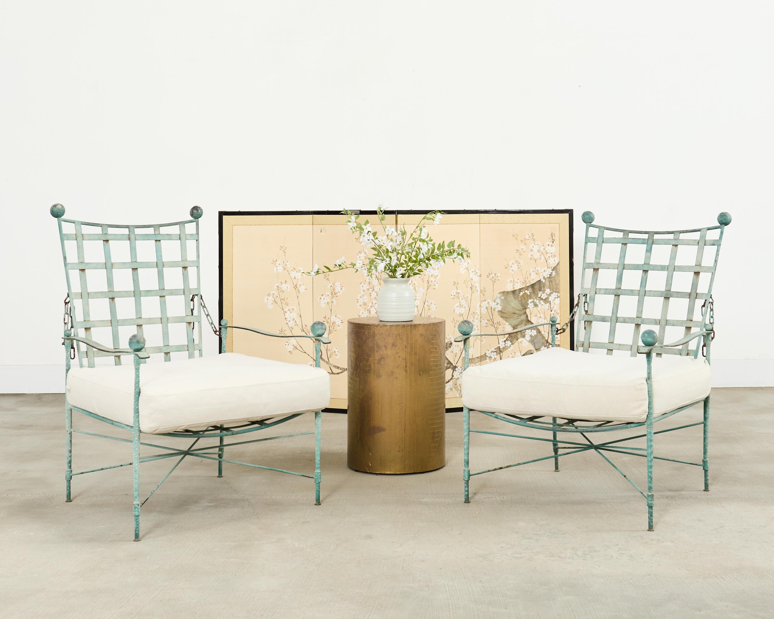 Authentic pair of Italian of mid-century modern patio and garden adjustable chain-back Amalfi lounge chairs designed by Mario Papperzini for John Salterini. The iconic chairs feature wrought-iron frames with neoclassical lattice back and seat in a