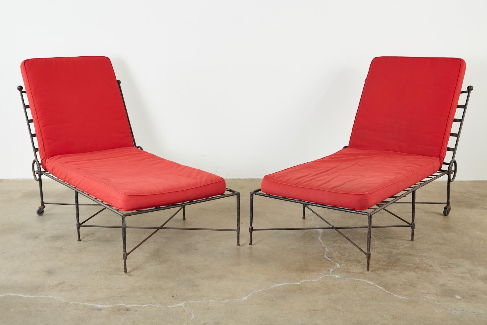 Mid-Century Modern pair of patinated iron garden chaise lounges or daybeds designed by Mario Papperzini for John Salterini. The lounges feature an aged patina with an iconic design and profile. Provenance: From a Michael Smith installation in