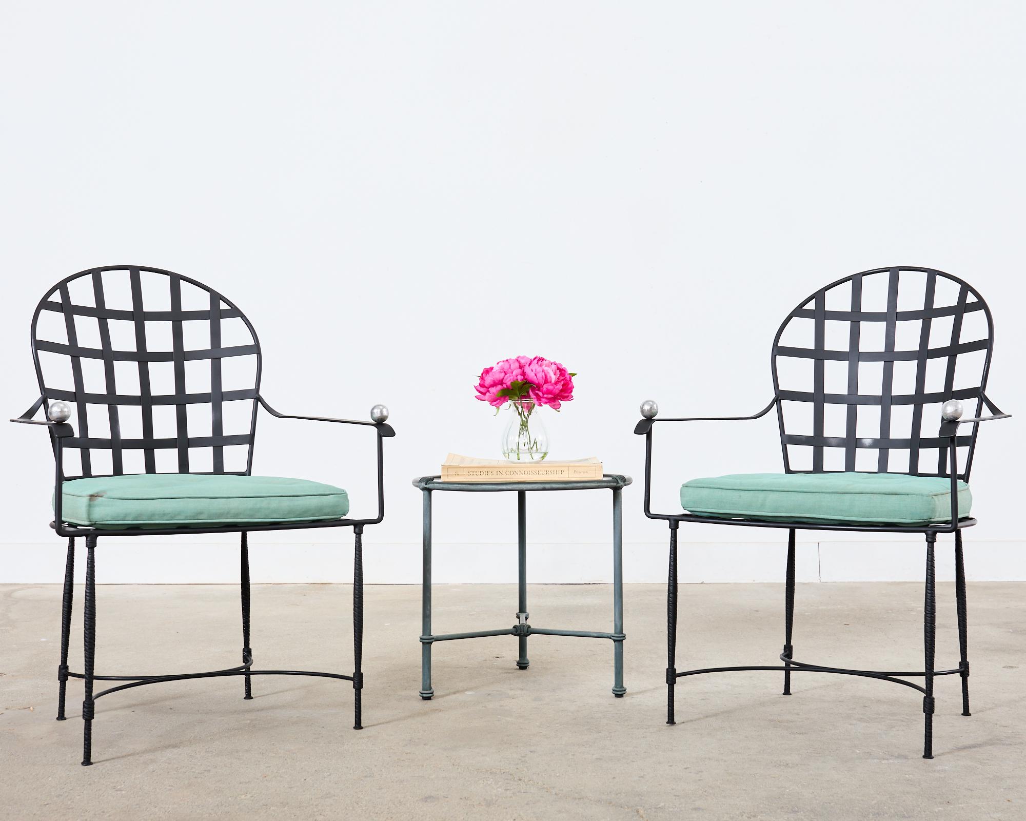 Iconic pair of iron patio and garden dining armchairs made in the manner and style of Mario Papperzini for John Salterini. The inspiration for the Janus et Cie round back Amalfi chair with its neoclassical style lattice inset seat and back. The