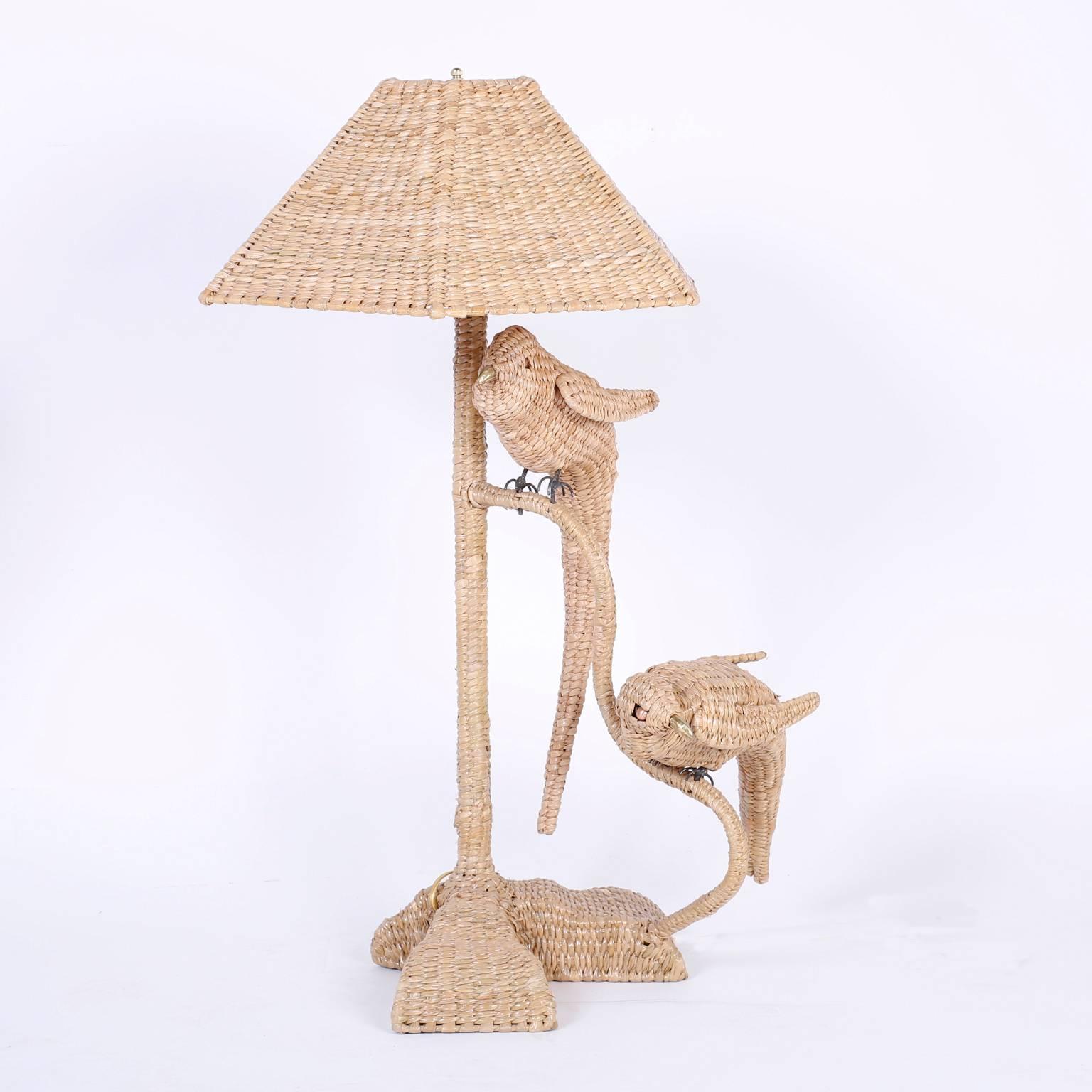 Pair of rustic modern wicker table lamps with two parrots on each, perched on a tree branch and your choice of a wicker or linen shade. Signed Mario Torres on a brass medallion. 

Measures: Height with wicker shade 34